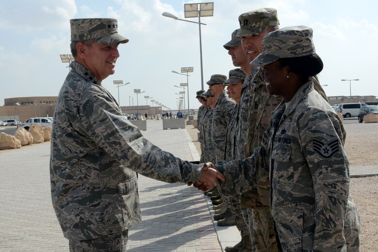 Air Force Chief of Staff Gen. Mark A. Welsh III, left, greets Airmen before attending a luncheon during his visit, Dec. 14, 2014, at Al Udeid Air Base, Qatar. Six Airmen assigned to Al Udeid were hand-picked to be coined by Welsh for their hard work and dedication to the mission. (U.S. Air Force photo/Senior Airman Kia Atkins)