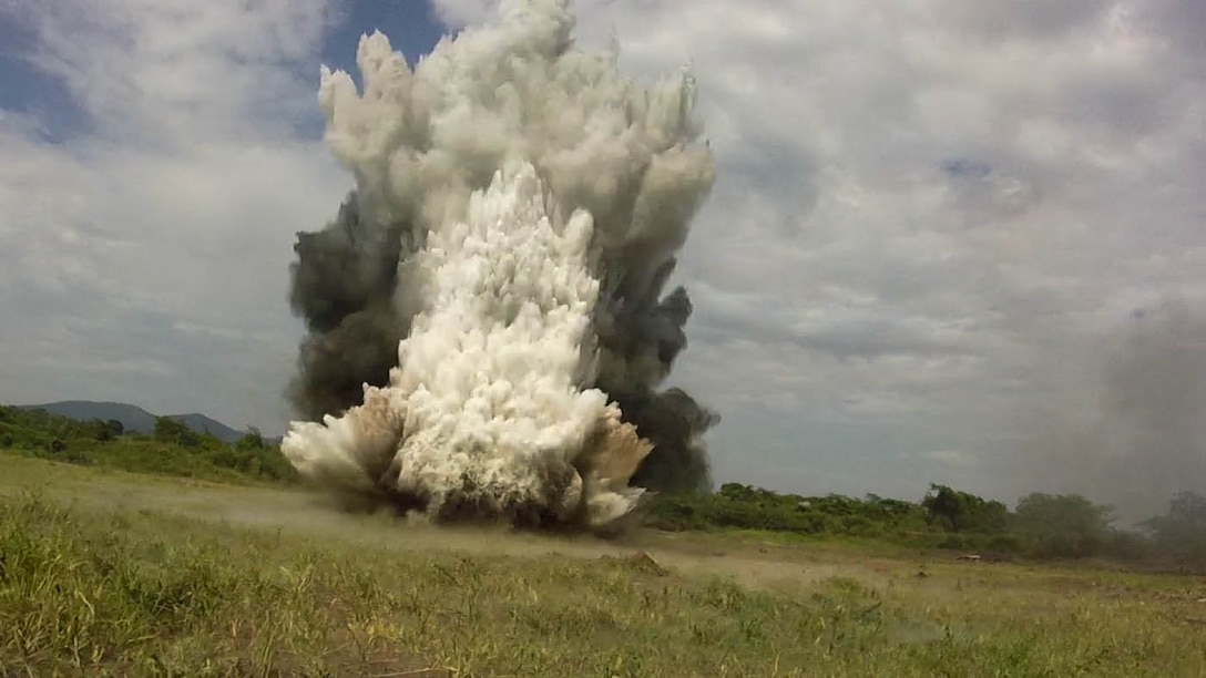 An explosion rips the ground apart during an explosive ordnance disposal demonstration between Marines with SPMAGTF Crisis Response-Africa and soldiers with the Ugandan People’s Defense Force in Camp Singo, Uganda, Nov. 13, 2014. Marines and Sailors with SPMAGTF Crisis Response-Africa were in Uganda from Oct. - Dec., training alongside the UPDF, focusing on infantry tactics, countering IEDs, and logistics.