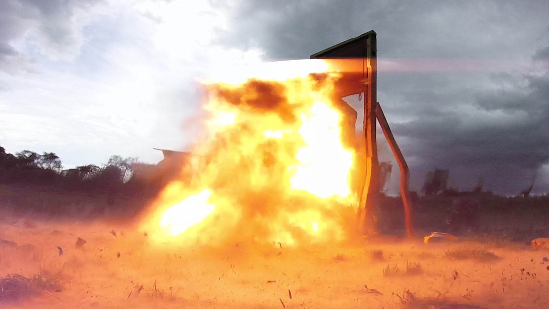 A breaching charge blows a door apart during an explosive ordnance disposal demonstration between Marines with SPMAGTF Crisis Response-Africa and soldiers with the Ugandan People’s Defense Force in Camp Singo, Uganda, Dec. 2, 2014. Marines and Sailors with SPMAGTF Crisis Response-Africa were in Uganda from Oct. - Dec., training alongside the UPDF, focusing on infantry tactics, countering IEDs, and logistics. 