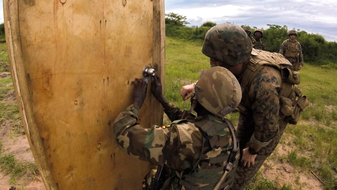 An explosive ordnance disposal technician conducts a breaching class with a soldier with the Ugandan People’s Defense Force in Camp Singo, Uganda, Dec. 2, 2014. Marines and Sailors with SPMAGTF Crisis Response-Africa were in Uganda from Oct. - Dec., training alongside the UPDF, focusing on countering improvised explosive devices, land navigation and logistics. 