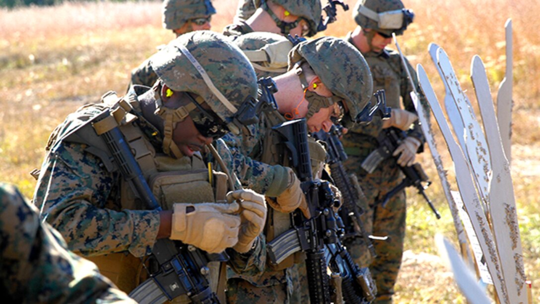 Marines with Bravo Company, Battalion Landing Team 3rd Battalion, 6th Marine Regiment, 24th Marine Expeditionary Unit, review their targets during a weapons calibration exercise at Camp Lejeune, N.C., Nov. 7, 2014. The Marines conducted the training to ensure all weapon systems are working properly and are ready for the upcoming deployment at the end of the year. Bravo Co. is the BLT’s Light Armored Reconnaissance detachment from 2nd Light Armored Reconnaissance Battalion, 2nd Marine Division.  (U.S. Marine Corps photo by Lance Cpl. Austin A. Lewis)
