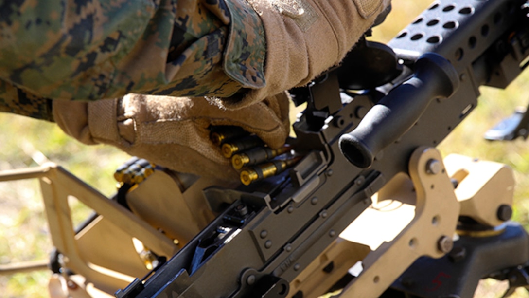 A Marine with Bravo Company, Battalion Landing Team 3rd Battalion, 6th Marine Regiment, 24th Marine Expeditionary Unit, loads 7.62mm ammunition into an M240B machine gun during a weapons calibration exercise at Camp Lejeune, N.C., Nov. 7, 2014. The Marines conducted the training to ensure all weapon systems are working properly and are ready for the upcoming deployment at the end of the year. Bravo Co. is the BLT’s Light Armored Reconnaissance detachment from 2nd Light Armored Reconnaissance Battalion, 2nd Marine Division.  (U.S. Marine Corps photo by Lance Cpl. Austin A. Lewis)