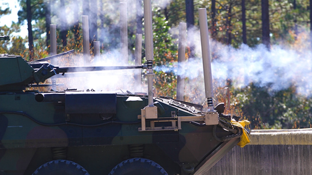 A light armored vehicle operated by Marines with Bravo Company, Battalion Landing Team 3rd Battalion, 6th Marine Regiment, 24th Marine Expeditionary Unit, fire a 25 mm training round through a tracer barrel during a weapons calibration shoot at Camp Lejeune, N.C., Nov. 7, 2014. The Marines conducted the training to ensure all weapon systems are working properly and are ready for the upcoming deployment at the end of the year. (U.S. Marine Corps photo by Lance Cpl. Austin A. Lewis)