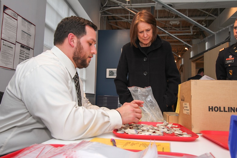 ALEXANDRIA, Va. -- Nick Gervasoni , a Veterans Curation Program laboratory technician, shows Jo-Ellen Darcy, the  assistant secretary of the Army for civil works, on Dec. 3, 2014, how he sorts and documents ceramics recovered from Fort Norfolk in the late 1970. Giacobozzi is a military veteran enrolled in the curation program, which provides recently separated military veterans with employment and archaeological training while also providing the veterans with resume writing assistance and interview skills over a five month period.  (U.S. Army photo/Patrick Bloodgood)