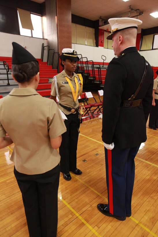 Miya Henson is inspected by Lt. Col. Maxx Godsey Dec. 17 during Freeport High School’s NJROTC Annual inspection. “This program really promotes discipline and leadership and I’d recommend it to every student,” said Henson, Freeport High School’s NJROTC program executive officer and Freeport, New York, native. Godsey is the 1st Marine Corps District executive officer.