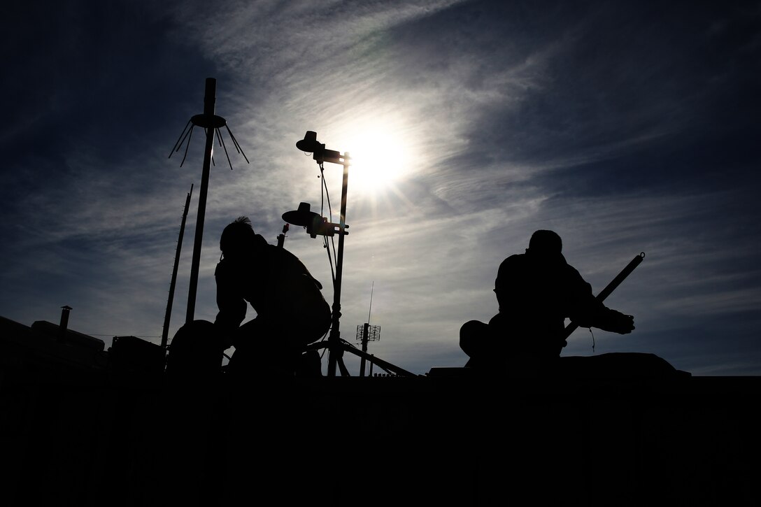 Lance Cpl. Homero Campos, left, and Lance Cpl. Chara J. Savoey, set up a hasty communications tower at Bombing Target Range 11, Piney Island, N.C., Dec. 18, 2014. Campos is an unmanned aerial vehicle maintainer with Marine Unmanned Aerial Vehicle Squadron 2 and native of Kingston, N.Y. Savoey is a field radio operator with the squadron and is native of Oakland, Calif.