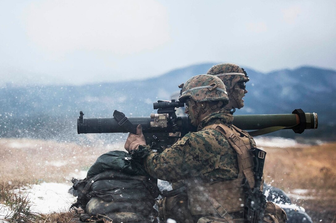 Lance Cpl. Casey T. Saunders, left, fires a shoulder-launched multipurpose assault weapon as Lance Cpl. Samuel S. Jacobson clears his back blast area Dec. 6 during Forest Light 15-1 at the Oyanohara Training Area in Yamato, Kumamoto prefecture, Japan. Forest Light is a routine, semi-annual exercise designed to enhance the U.S. and Japan military partnership, solidify regional security agreements and improve individual and unit-level skills. Saunders, from Easton, Connecticut, and Jacobson, from Bowie, Maryland, are infantry assaultmen with 2nd Battalion, 9th Marine Regiment, currently assigned to 4th Marine Regiment, 3rd Marine Division, III Marine Expeditionary Force, under the unit deployment program. 