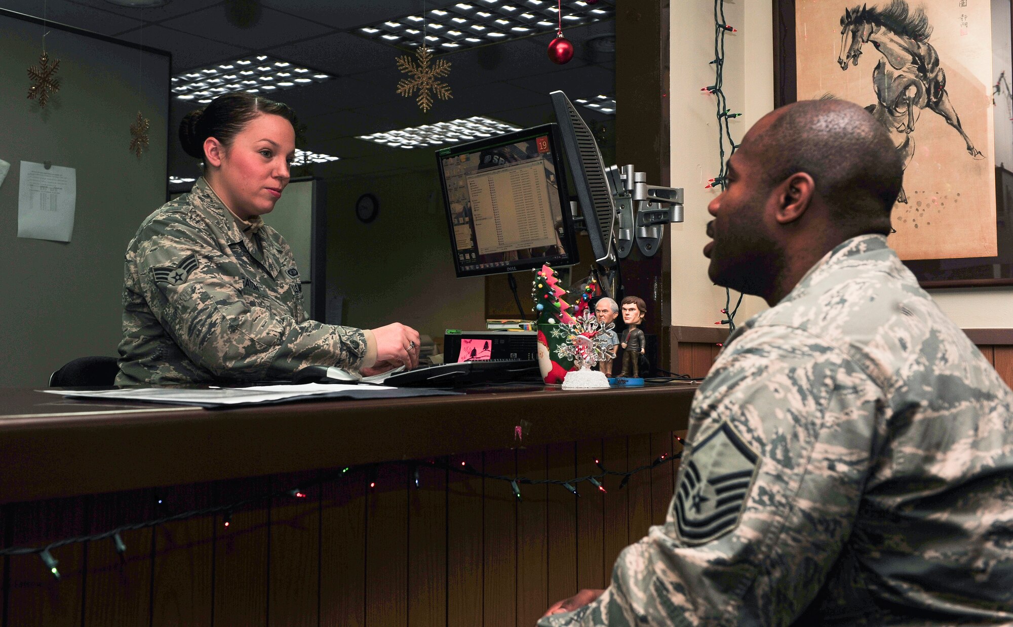 Senior Airman Elizabeth Heaton, 51st Comptroller Squadron customer service technician, out-processes Master Sgt. Marvin Wallace, 51st Fighter Wing Command Post NCO in charge, from finance Dec. 19, 2014 at Osan Air Base, Republic of Korea. Heaton is this week’s Airman Spotlight winner. (U.S. Air Force photo by Senior Airman David Owsianka)