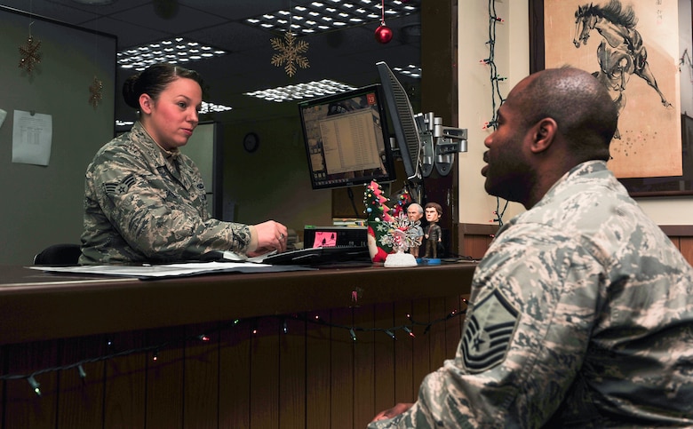 Senior Airman Elizabeth Heaton, 51st Comptroller Squadron customer service technician, out-processes Master Sgt. Marvin Wallace, 51st Fighter Wing Command Post NCO in charge, from finance Dec. 19, 2014 at Osan Air Base, Republic of Korea. Heaton is this week’s Airman Spotlight winner. (U.S. Air Force photo by Senior Airman David Owsianka)