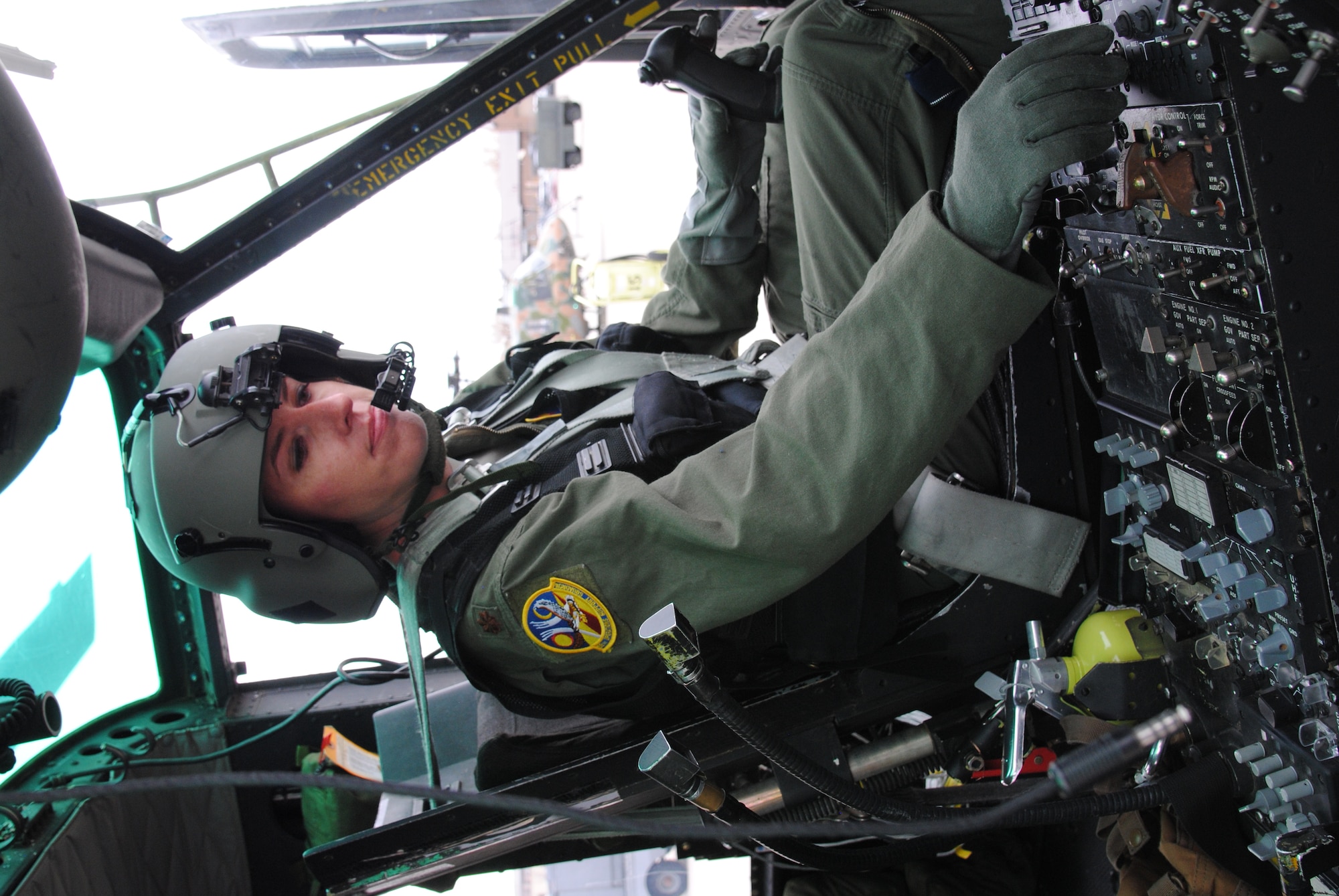 Maj. Mary Clark, a UH-1N Huey instructor pilot and 58th Operations Support Squadron assistant director of operations, conducts a pre-flight inspection Dec. 16.  (Photo by Jim Fisher)