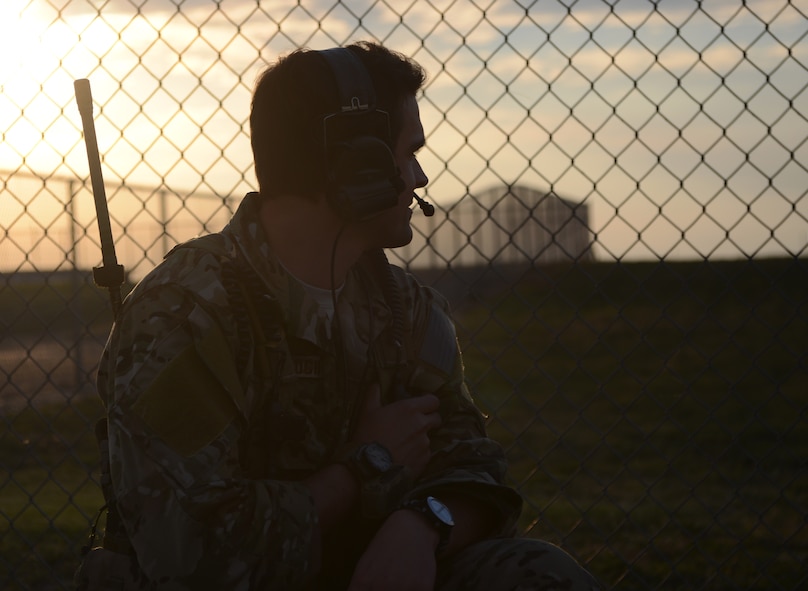 A U.S. Air Force joint terminal attack controller from the 66th Weapons Squadron (WPS), from Nellis Air Force Base, Nev., communicates with the aircrew of a U.S. Air Force B-1B Lancer Oct. 21, 2014, at Snyder Electronic Warfare Range, Snyder, Texas. During the simulated airfield seizure, B-1B Lancer and C-130J aircrews from Dyess Air Force Base, Texas, coordinated with JTACs from the 66th WPS to infiltrate and overtake an airfield which was previously under enemy control. (U.S. Air Force photo by Senior Airman Peter Thompson/Released)