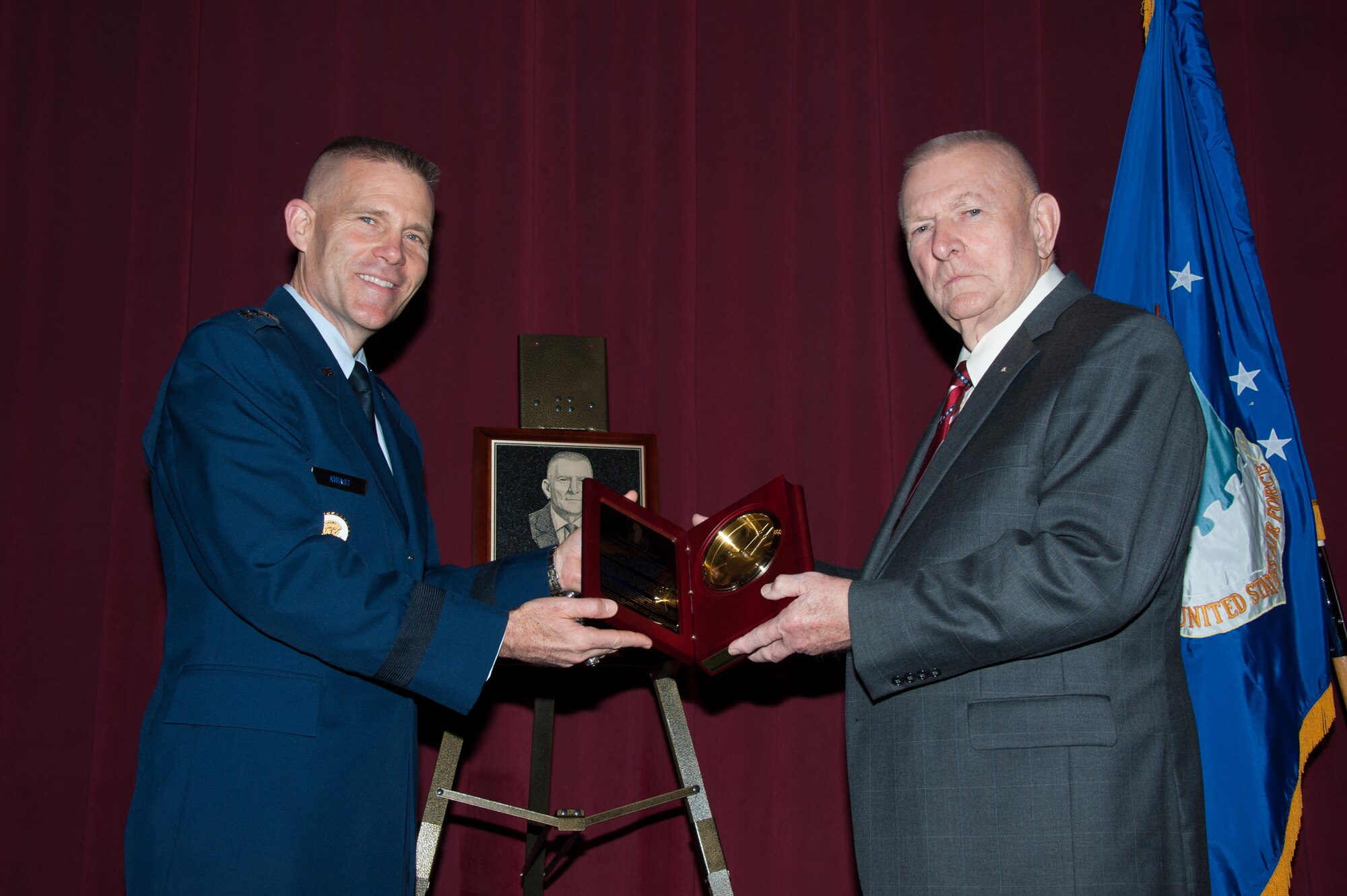 Lt. Gen. Steven Kwast, Air University commander, presents Gene Kranz with the Air Force ROTC Distinguished Alumni Award during a ceremony Dec. 16, 2014, at Maxwell Air Force Base, Alabama. Kranz, who received his commission through the ROTC program at Saint Louis University in 1954, was the flight director for the Apollo 13 mission in April 1970 that ended successfully following an explosion aboard the space capsule. Kranz was selected for the distinction because of his exceptional meritorious service to the Air Force and NASA for more than 40 years. (US Air Force photo by Melanie Rodgers Cox/Released)