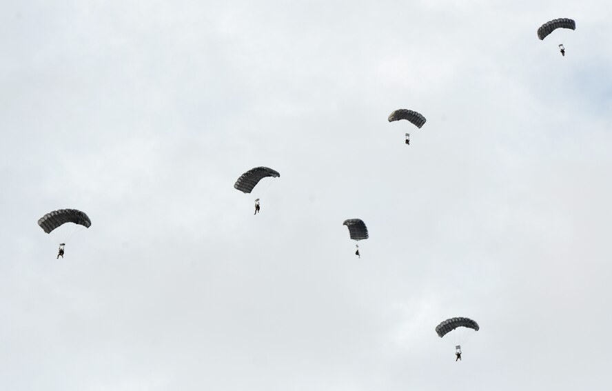 U.S. Army Special Forces Soldiers parachute toward a simulated airfield after a high-altitude low-opening exit from a C-130J assigned to the 317th Airlift Group from Dyess Air Force Base, Texas, Oct. 21, 2014, at Snyder Electronic Warfare Range, Snyder, Texas. During a simulated airfield seizure hosted by Dyess’ 77th Weapons Squadron, U.S. Air Force joint terminal attack controllers from the 66th Weapons Squadron at Nellis Air Force Base, Nev., coordinated an assault landing of Army Special Forces while U.S. Air Force B-1B’s from Dyess provided close air support. (U.S. Air Force photo by Senior Airman Peter Thompson/Released)