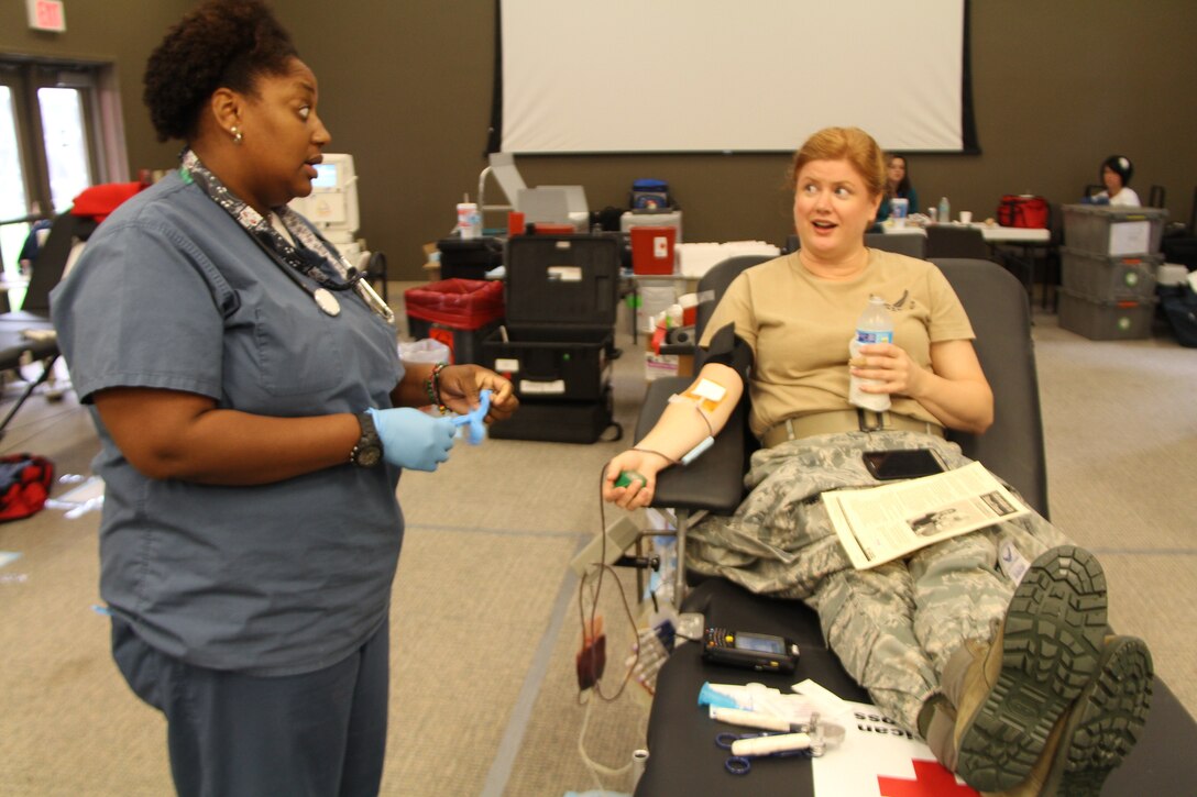 A Red Cross worker prepares the rubber gloves during the final stage of a blood donation held recently at the 932nd Airlift Wing.  Many members of the wing and other base agencies came to the Air Force Reserve Command's Illinois unit to donate. Each blood donation is highly important and is used further down the line to save three lives according to the Red Cross workers. (U.S. Air Force photo/Maj. Stan Paregien)