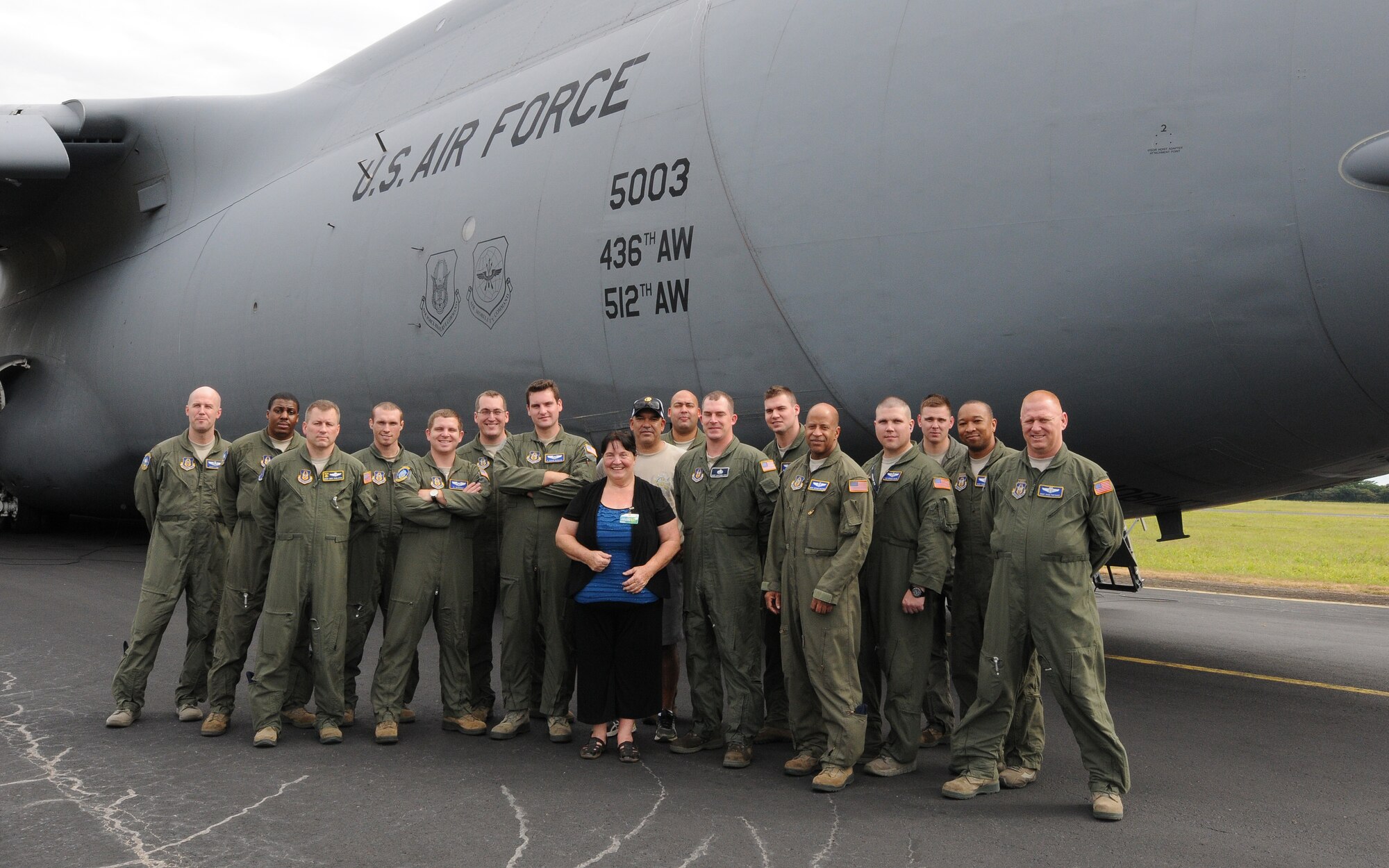 Donna Wright, co-founder of World Missions Outreach poses for a photo with
U.S. Air Force Reserve Airmen from the 512th Airlift Wing in Nicaragua, Dec. 20, 2014. The Airmen delivered humanitarian supplies to Nicaragua aboard a C-5M Super Galaxy just in time for the Holidays. 125,000 pounds of food and educational equipment were airlifted to Nicaragua's Augusto C. Sandino International Airport in Managua. The massive delivery was made possible through the Denton Program, a Department of Defense humanitarian assistance transportation program that utilizes space available military air, surface and sea-lift assets. The supplies were provided to World Missions Outreach, which is an international nonprofit organization based in Nicaragua that provides food, education, medical and ministry services to the country's citizens.(U.S. Air Force photo/2nd Lt. Steve Lewis)
