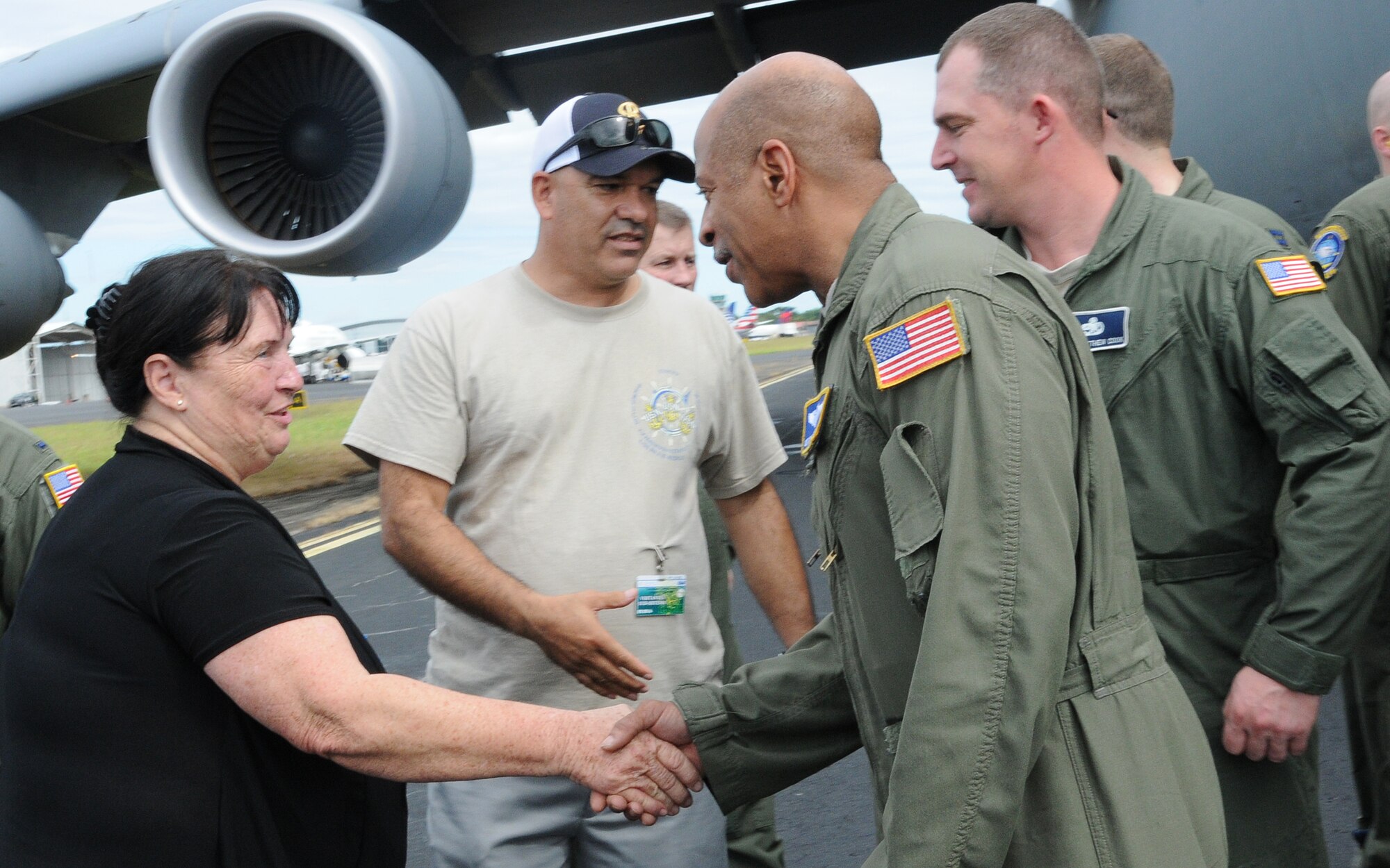 Donna Wright, co-founder of World Missions Outreach, thanks U.S. Air Force Reserve Airmen from the 512th Airlift Wing after they delivered humanitarian supplies to Nicaragua aboard a C-5M Super Galaxy Dec. 20, 2014. 125,000 pounds of food and educational equipment were airlifted to Nicaragua's Augusto C. Sandino International Airport in Managua. The massive delivery was made possible through the Denton Program, a Department of Defense humanitarian assistance transportation program that utilizes space available military air, surface and sea-lift assets. The supplies were provided to WMO, which is an international nonprofit organization based in Nicaragua that provides food, education, medical and ministry services to the country's citizens.(U.S. Air Force photo/2nd Lt. Steve Lewis)