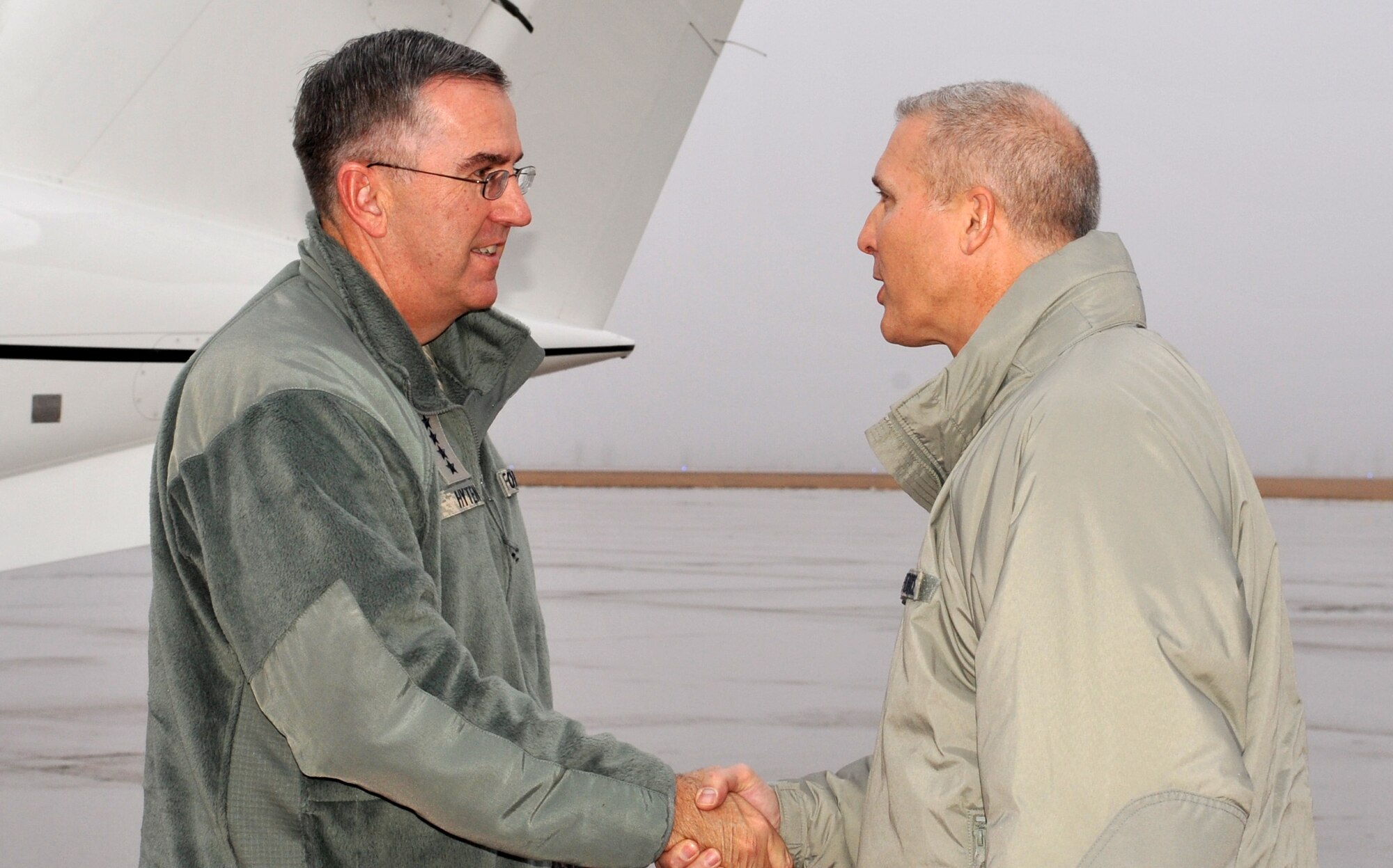 Gen. John E. Hyten, Air Force Space Command commander, greets Col. Paul Bauman, 319th Air Base Wing commander, Dec. 22, 2014 on Grand Forks Air Force Base, N.D. Hyten made the trip from Peterson Air Force Base, Colo., to visit members of Cavalier Air Station, N.D., ahead of the winter holidays. (U.S. Air Force photo/Staff Sgt. Susan L. Davis)
