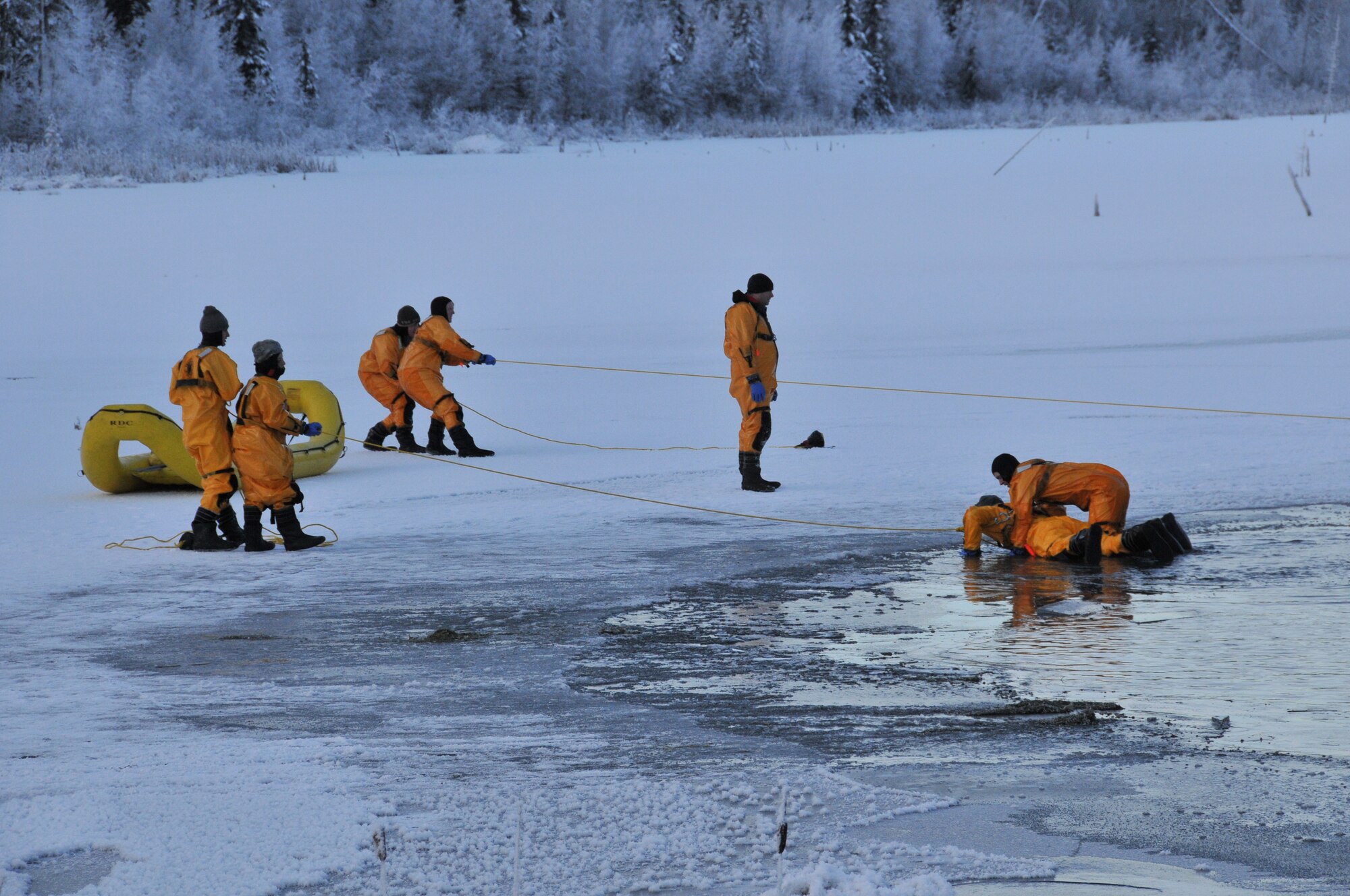 JOINT BASE ELMENDORF-RICHARDSON -- Firefighters of the 673d Civil Engineer Squadron, Joint Base Elmendorf-Richardson, deal with heat, fire and water on a regular basis. Annually though, these firefighters practice their ice water rescue techniques. The training prepares firefighters on the proper methods of water rescue; when minutes and seconds count, it pays to be ready to act instinctively. People panic because they haven't practiced, and practice is just what the firefighters were doing last weekend. Given the number of lakes and open-water sources on and around JBER, water activity and snowmachines could lead to a higher volume of incidents. (U.S. Air Force photo/Mr. Tommie Baker)
