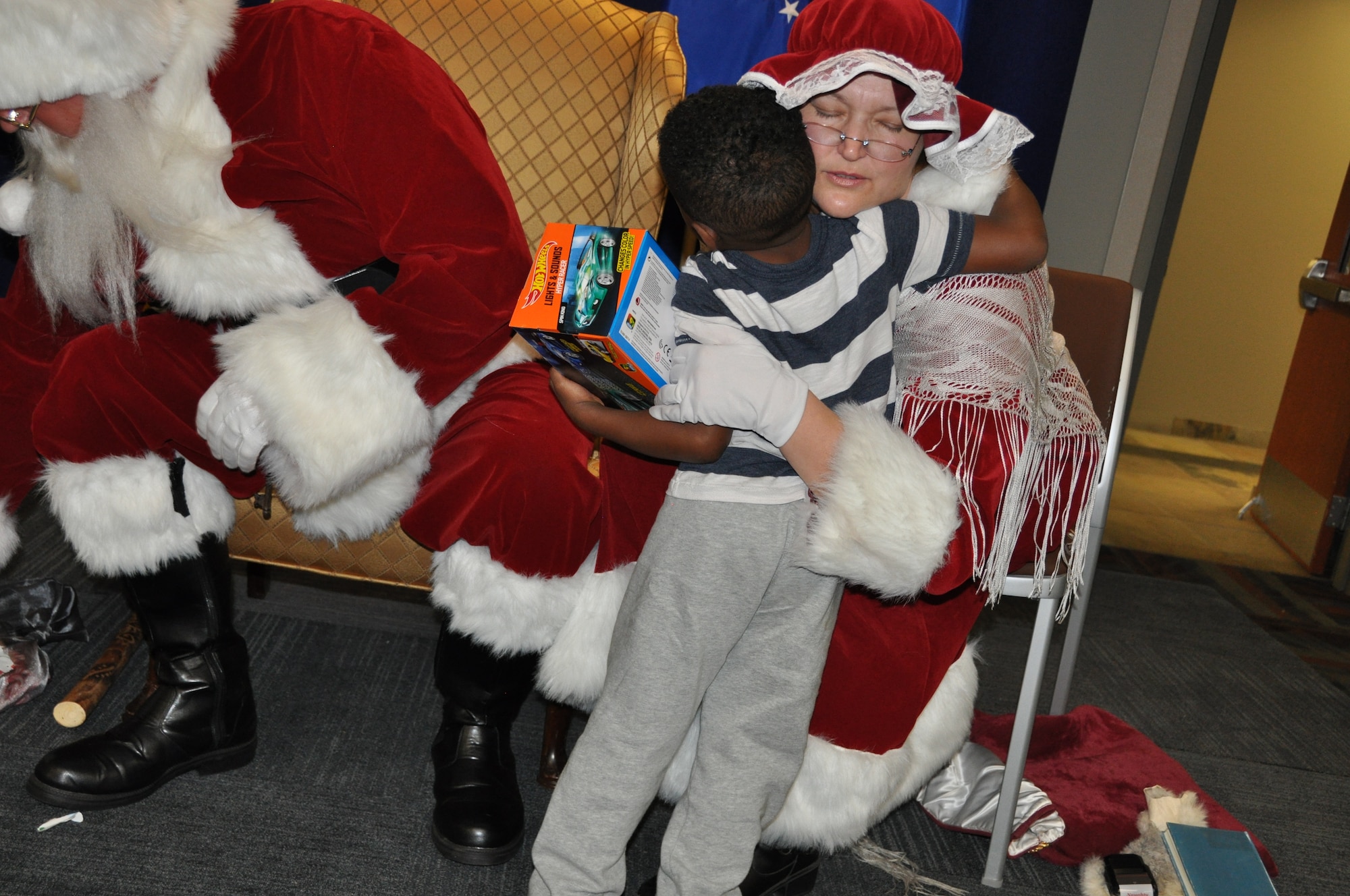 Mrs. Claus hugs a child during her visit to the Air Reserve Personnel Center Dec. 19, 2014, on Buckley Air Force Base, Colo. Brig. Gen. Samuel "Bo" Mahaney, ARPC commander, introduced Santa Claus, Mrs. Claus and Sparkle the elf to excited families and children as he discussed the relationship with Santa Claus and the Air Force, which dates back decades. (U.S. Air Force photo/Tech. Sgt. Rob Hazelett)