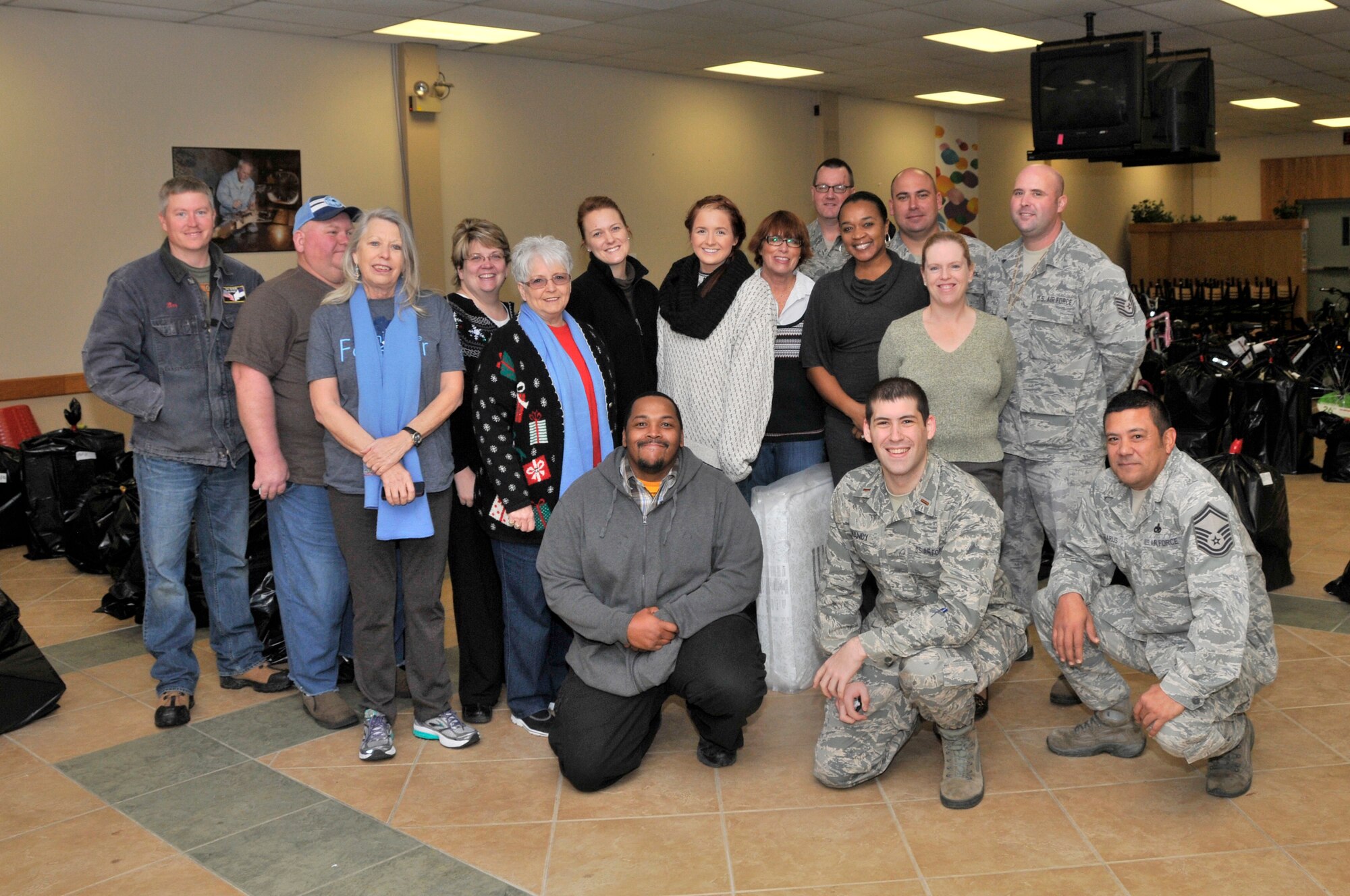 Pictured at the AEDC Angel Tree collection location are AEDC volunteers and counselors with the Center for Family Development (CFD), which includes the South Central Relative Caregiver Program and the Healthy Families Program. They gathered on Dec. 10 to load Angel Tree gift donations into vehicles for families in need. Volunteers shown here kneeling left to right are Art Walker, AEDC; 2nd Lt. Christopher Handy, AEDC; Senior Master Sgt. Patrick Lazarus, AEDC: Standing left to right are Ben Fletcher, CFD; Charles Roberts, CFD; Sue Fletcher, CFD; Sandra Roberts, CFD; Mary Faxon, CFD; Mallory Garner, CFD; Emily Reese, CFD; Janet Gammon, AEDC; Master Sgt. Jason Nelson, AEDC; Kim Vanzant, AEDC; Tech. Sgt. Rodney Clemmons, AEDC; Carrie Barham, AEDC; and Tech. Sgt. Kristopher Boal, AEDC. (Photo by Jacqueline Cowan)
