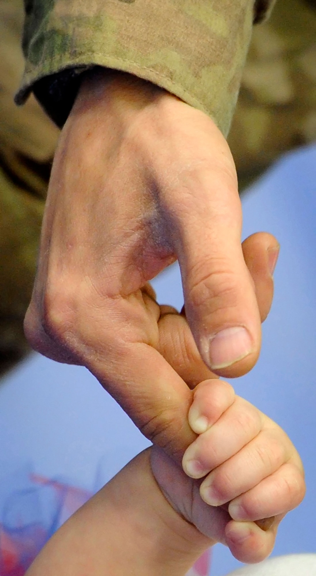 Army Sgt. Douglas McCreery leads his one-year old daughter Alexandrea by the hand as they leave for home after the redeployment ceremony for the 109th Transportation Company, 17th Combat Sustainment Support Battalion, 2d Engineer Brigade, U.S. Army Alaska, at the Buckner Physical Fitness Center, Thursday, Jan. 30, 2014, on Joint Base Elmendorf-Richardson, Alaska.  The Muleskinners of the 109th Transportation Company deployed to Afghanistan in support of Operation Enduring Freedom for 7 months, and they provided transportation and convoy security for military and host nation transportation assets. (U.S. Air Force photo/Justin Connaher)