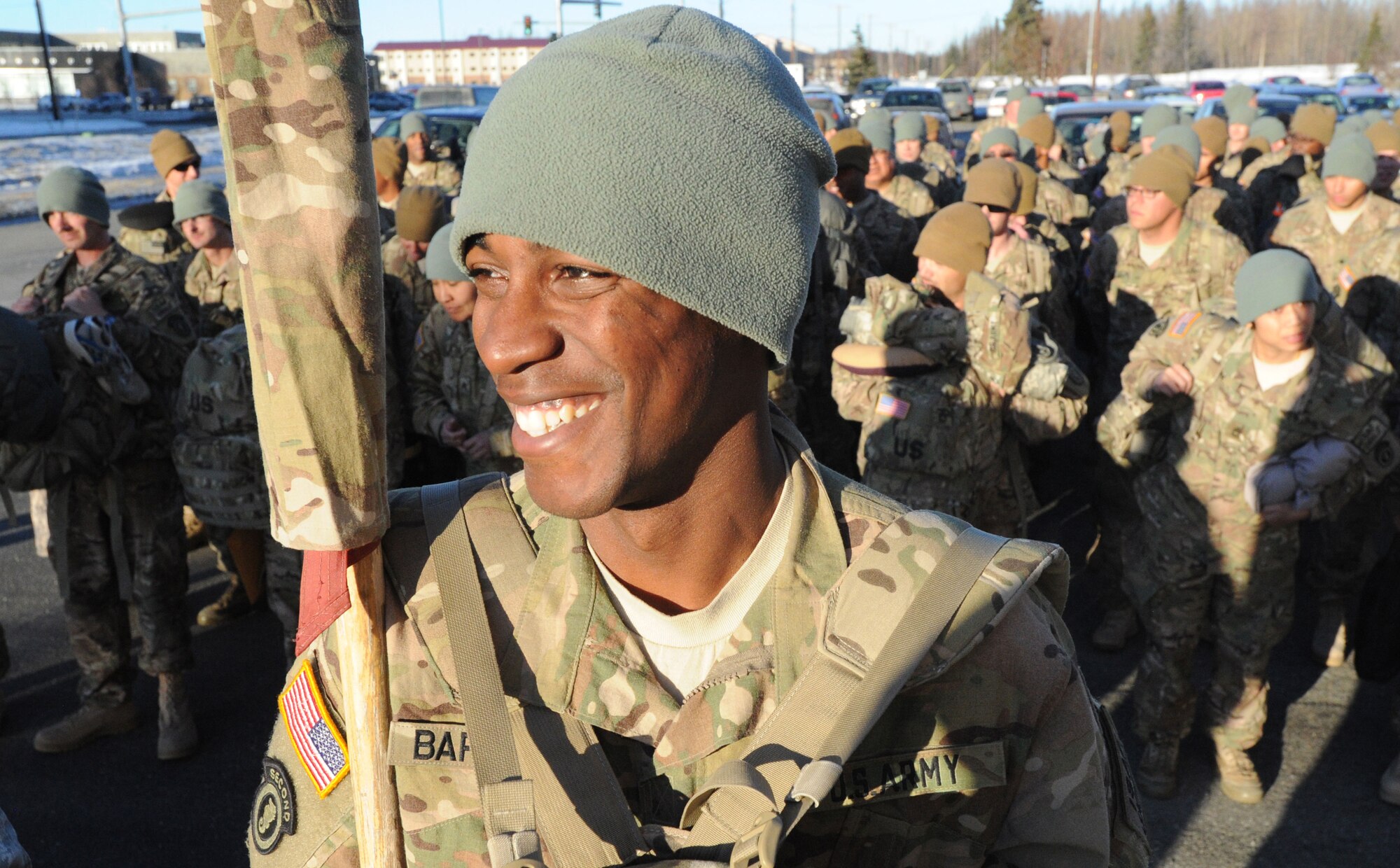 Army Pfc. Ricky Bernard stands in front of his company with the unit guidon the redeployment ceremony for the 109th Transportation Company, 17th Combat Sustainment Support Battalion, 2d Engineer Brigade, U.S. Army Alaska, at the Buckner Physical Fitness Center, Thursday, Jan. 30, 2014, on Joint Base Elmendorf-Richardson, Alaska.  The Muleskinners of the 109th Transportation Company deployed to Afghanistan in support of Operation Enduring Freedom in June 2013.  While there, they provided transportation and convoy security for military and host nation transportation assets. (U.S. Air Force photo by Justin Connaher/Released)