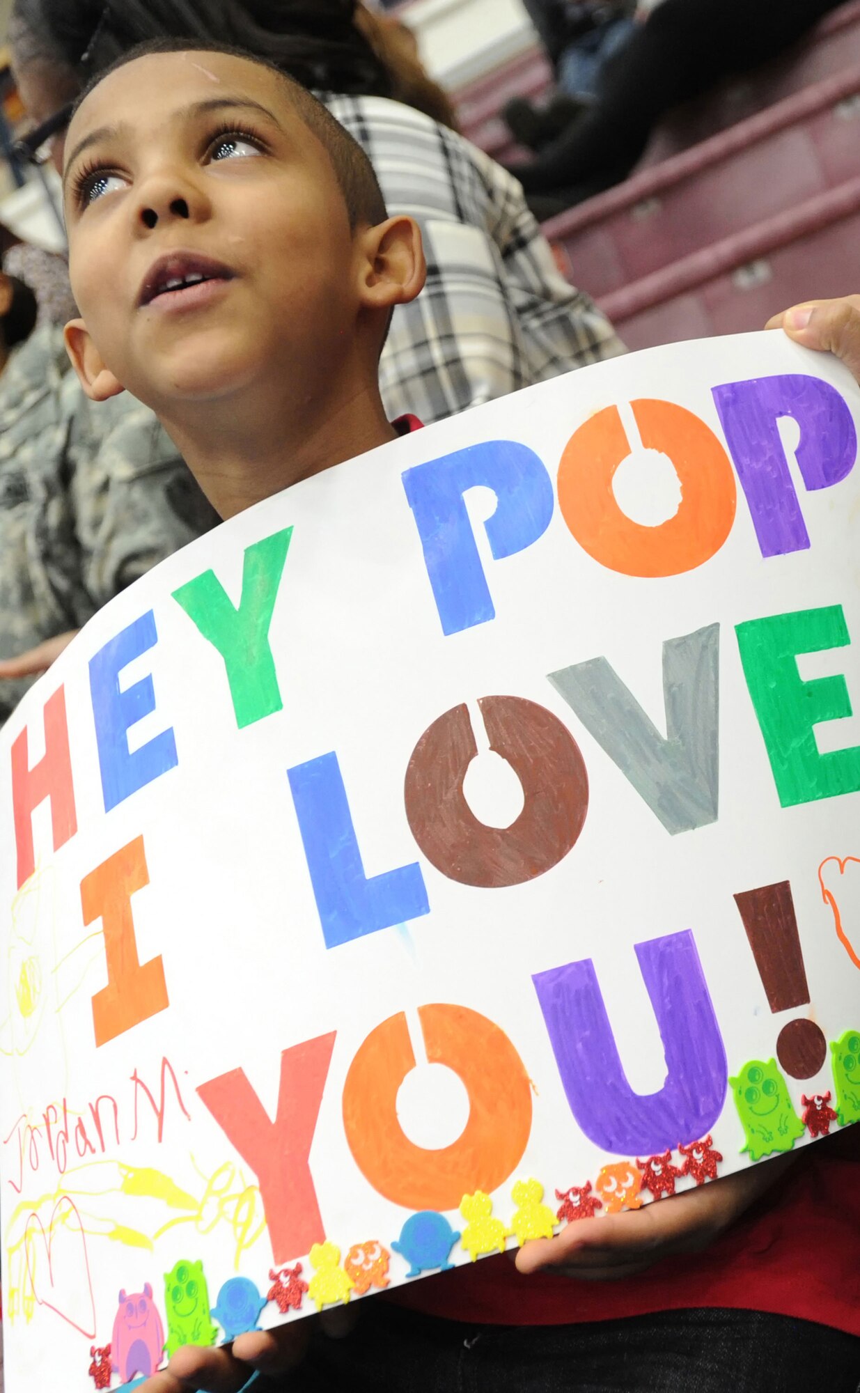 Jordan Martinez, 7, waits for his father Army Sgt. Eric Martinez before the redeployment ceremony for the 109th Transportation Company, 17th Combat Sustainment Support Battalion, 2d Engineer Brigade, U.S. Army Alaska, at the Buckner Physical Fitness Center, Thursday, Jan. 30, 2014, on Joint Base Elmendorf-Richardson, Alaska.  The Muleskinners of the 109th Transportation Company deployed to Afghanistan in support of Operation Enduring Freedom for 7 months, and they provided transportation and convoy security for military and host nation transportation assets. (U.S. Air Force photo/Justin Connaher)