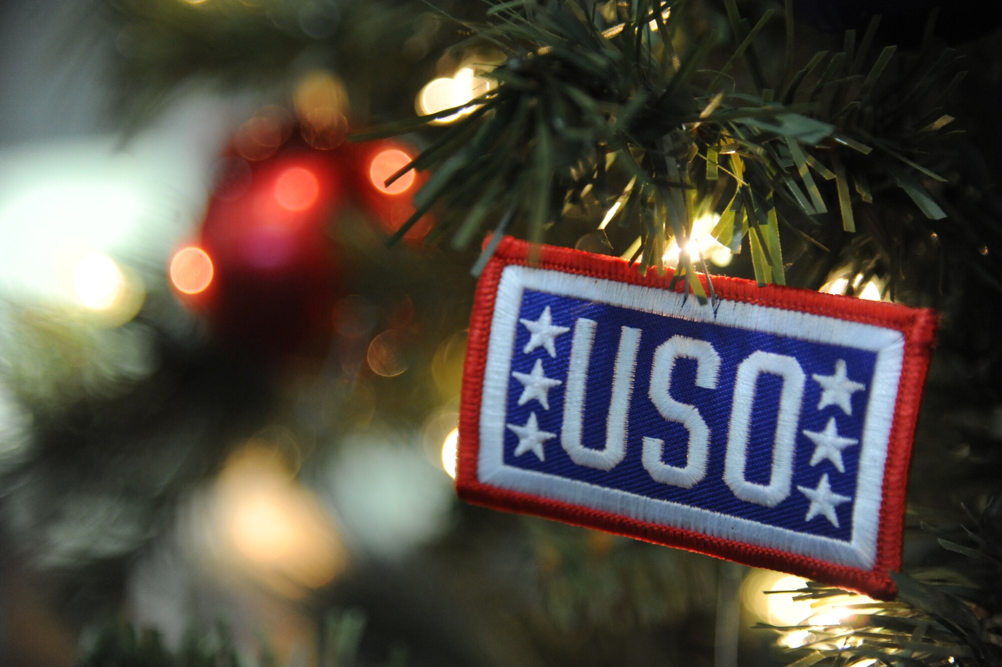 A USO ornament hangs on a Christmas Tree at the Gulfport-Biloxi International Airport Dec. 19, 2014.  Keesler personnel volunteered their time at the USO room to assist with making service members more comfortable during flight lay-overs. (U.S. Air Force photo by Kemberly Groue)