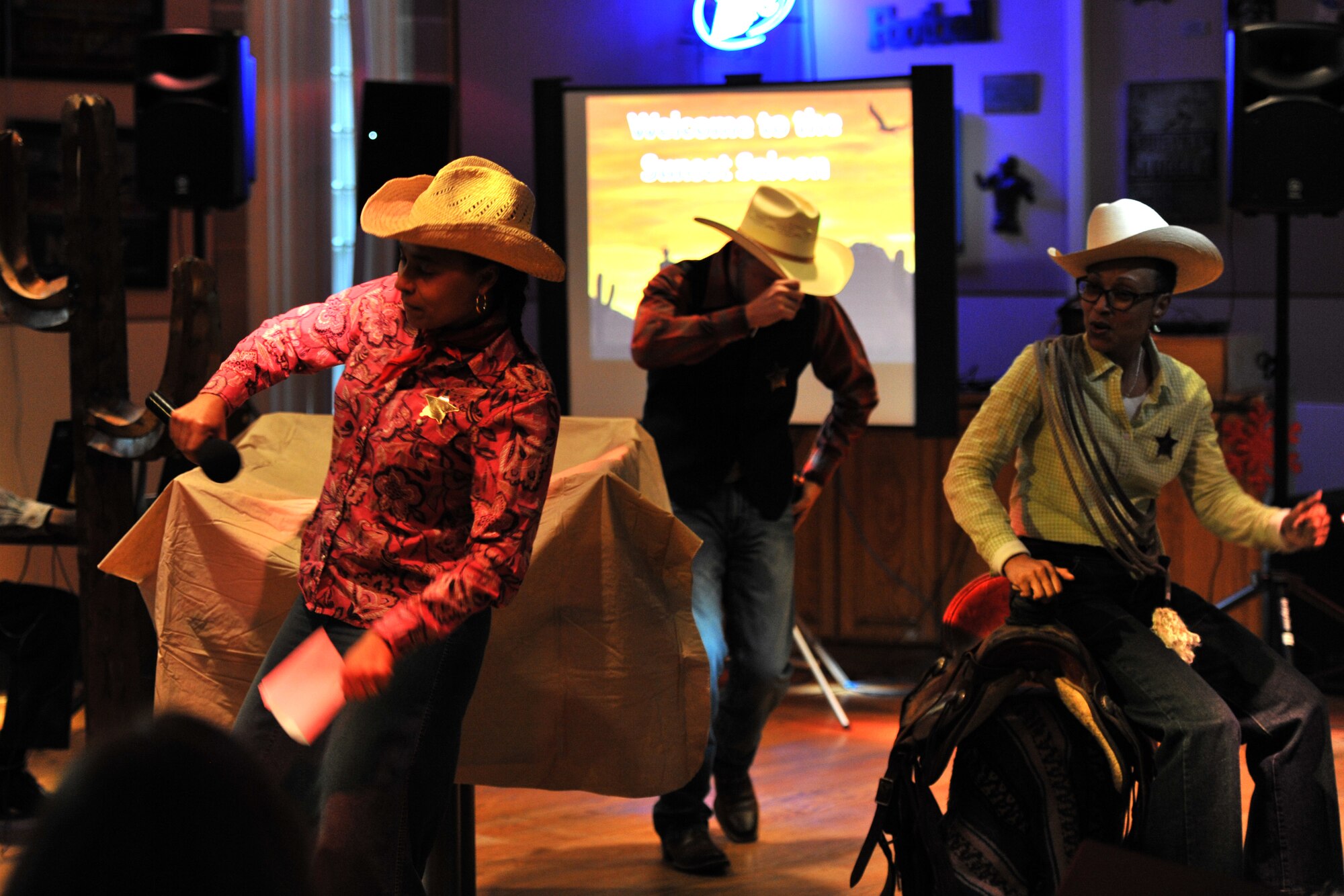 GOODFELLOW AIR FORCE BASE, Texas – The Airman and Family Readiness Center preforms their western-themed presentation during Operation Bar Rescue at the Event Center Dec. 17. Their ideas included a complete renovation with bar stools as saddles, new tables and a new bar top.