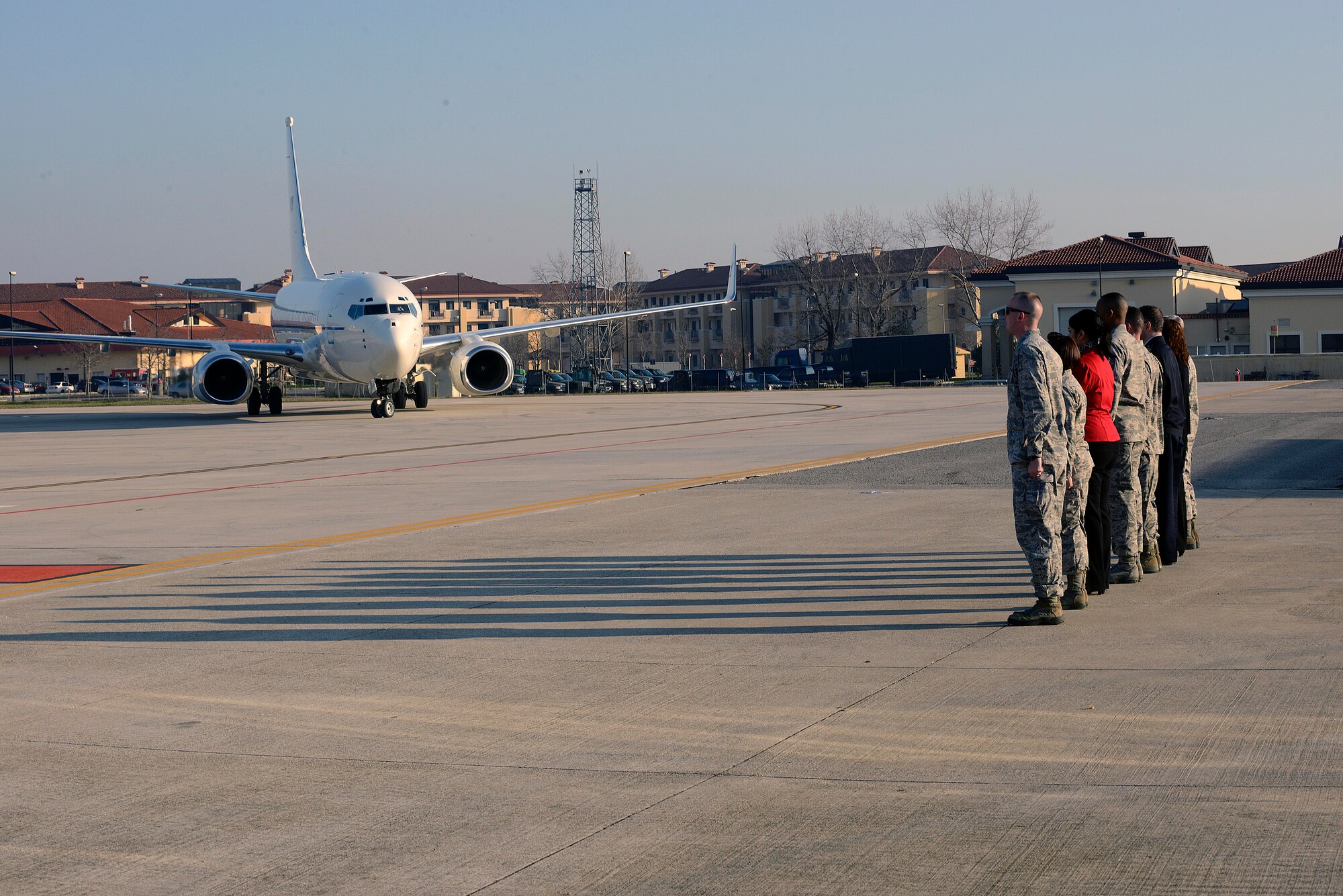 Team Aviano members stand at attention as the aircraft carrying U.S. Air Force Chief of Staff Mark A. Welsh III arrives, Dec. 21, 2014, at Aviano Air Base, Italy. During their visit to the 31st Fighter Wing, Welsh and Grant received a mission brief, participated in an open discussion during breakfast with Airmen and hosted an all-call to address some of the main challenges the Air Force will face in 2015 and beyond. (U.S. Air Force photo by Airman 1st Class Ryan Conroy/Released)