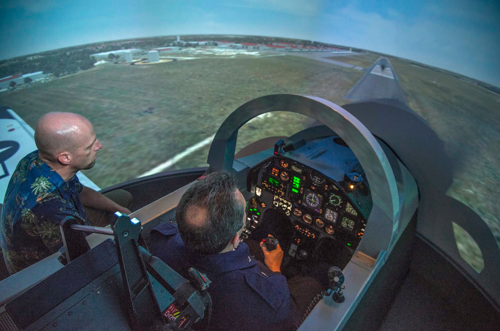 Brazilian air force Maj. Gen. Ricardo Magalhaes, defense and air attaché, flies a T-6 simulator Dec. 11, 2014 during a visit to the 435th Flying Training Squadron at Joint Base San Antonio-Randolph, Texas. The flight simulator creates a realistic environment for students to experience flying a plane. (U.S. Air Force photo by Johnny Saldivar)