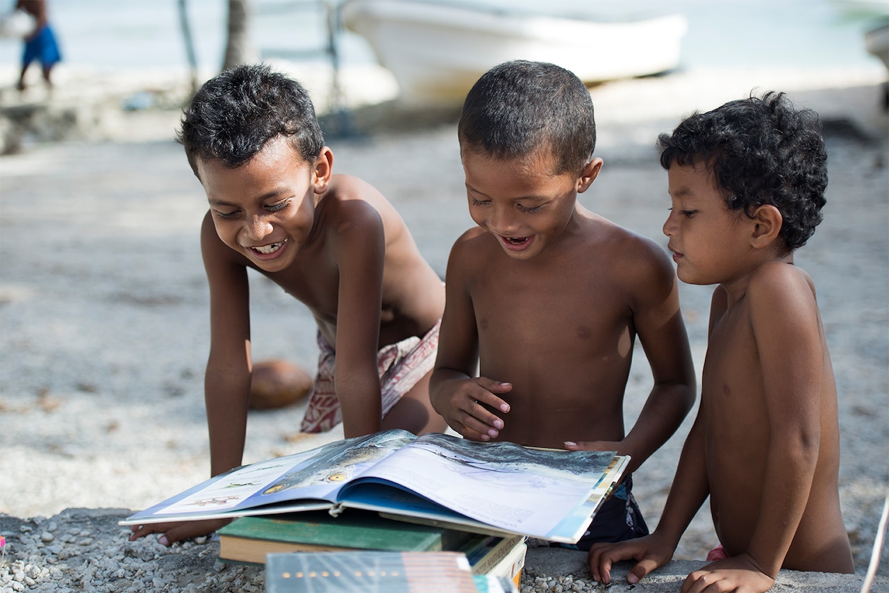 Children look through items received during Operation Christmas Drop Dec. 9, 2014, at Ulithi Atoll, Micronesia. U.S. Air Force photo