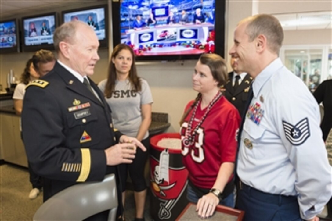 Army Gen. Martin E. Dempsey, chairman of the Joint Chiefs of Staff, meets with service members and their families while attending the Tampa Bay Buccaneers vs. Green Bay Packers football game at Raymond James Stadium in Tampa, Fla., Dec. 21, 2014. The service members attended the game as part of the National Football League's Salute to Service initiative. 