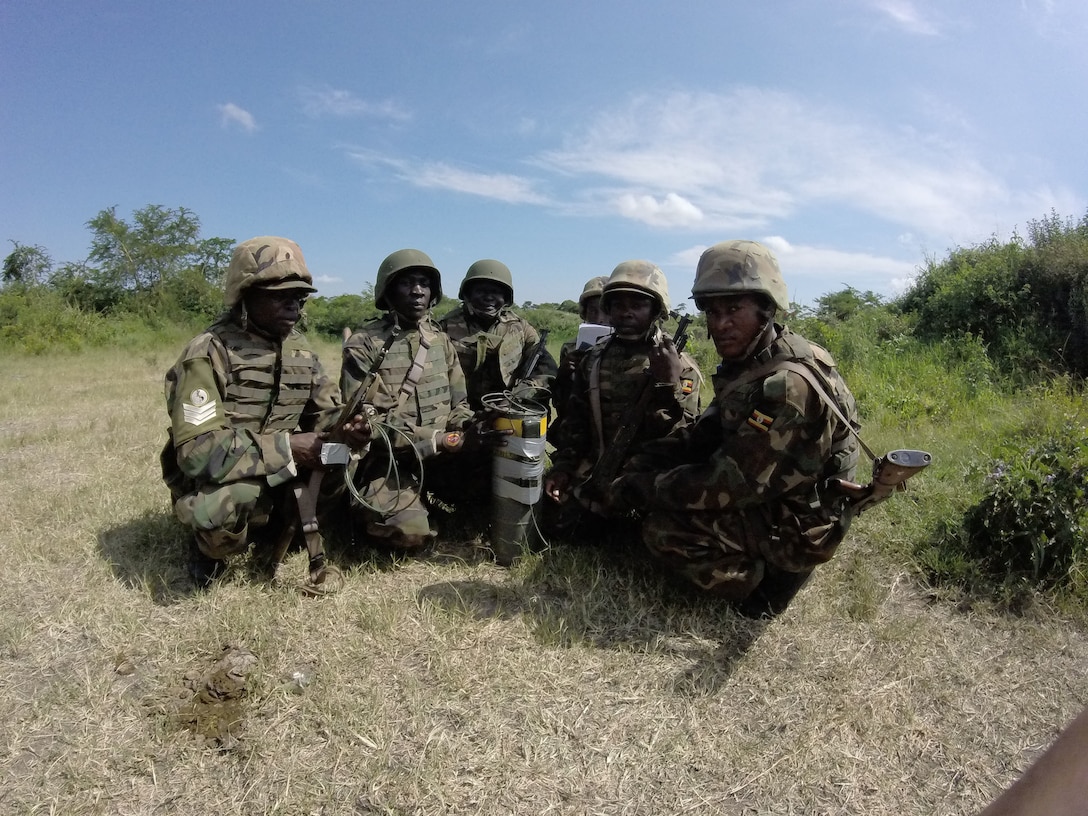 Soldiers with the Ugandan People’s Defense Force pose for a photo with an explosive training charge in Camp Singo, Uganda, Nov. 11, 2014. Marines and Sailors with SPMAGTF Crisis Response-Africa were in Uganda from Oct. - Dec., training alongside the UPDF, focusing on infantry tactics, countering IEDs, and logistics.(Courtesy Photo)