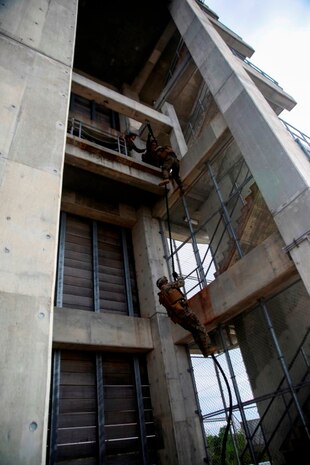 Marines practice their fast-roping skills Dec. 3 at the Camp Hansen rappel tower. The Marines gradually increased the difficulty, first rappelling without gear, then with their flak vests, and finally with their weapons. The Marines are with Company F, Battalion Landing Team 2nd Battalion, 4th Marines, 31st Marine Expeditionary Unit. (U.S. Marine Corps photo by Lance Cpl. Ryan C. Mains/Released)
