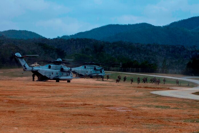 U.S. Marines with Company E, Battalion Landing Team, 2nd Battalion 4th Marines, 31st Marine Expeditionary Unit (MEU), offload from a CH-53 Super Stallion as they conduct a vertical assault during MEU Exercise (MEUEX), in Combat Town, Okinawa, Japan, Dec 10, 2014. BLT 2/4 is conducting training in preparation of their upcoming spring patrol.  (U.S. Marine Corps photo by GySgt Ismael Pena/Released)