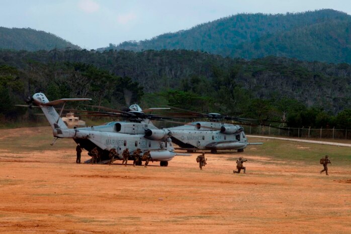 U.S. Marines with Company E, Battalion Landing Team, 2nd Battalion 4th Marines, 31st Marine Expeditionary Unit (MEU), offload from a CH-53 Super Stallion as they conduct a vertical assault during MEU Exercise (MEUEX), in Combat Town, Okinawa, Japan, Dec 10, 2014. BLT 2/4 is conducting training in preparation of their upcoming spring patrol.  (U.S. Marine Corps photo by GySgt Ismael Pena/Released)
