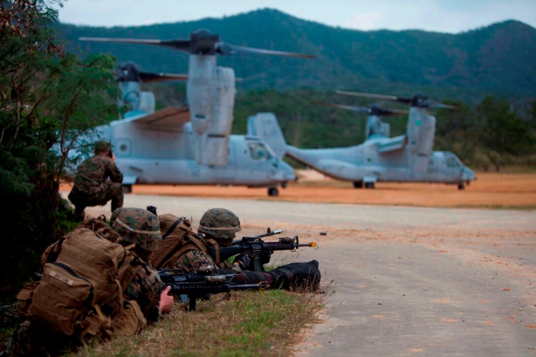 U.S. Marines with Company E, Battalion Landing Team, 2nd Battalion 4th Marines, 31st Marine Expeditionary Unit (MEU), provide security as Marines offload from a MV-22 Osprey as they conduct a vertical assault during MEU Exercise (MEUEX), in Combat Town, Okinawa, Japan, Dec 10, 2014. BLT 2/4 is conducting training in preparation of their upcoming spring patrol. (U.S. Marine Corps photo by GySgt Ismael Pena/Released)
