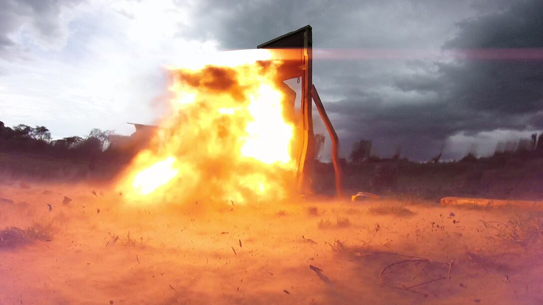 A breaching charge blows a door apart during an explosive ordnance disposal demonstration between Marines with SPMAGTF Crisis Response-Africa and soldiers with the Ugandan People’s Defense Force in Camp Singo, Uganda, Dec. 2, 2014. Marines and Sailors with SPMAGTF Crisis Response-Africa were in Uganda from Oct. - Dec., training alongside the UPDF, focusing on infantry tactics, countering IEDs, and logistics. (Courtesy Photo)