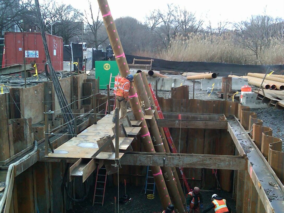 Battered (sloped) steel pipe pile being installed at the Riverway work area as part of the Muddy River Flood Risk Management Project, Boston, Massachusetts.