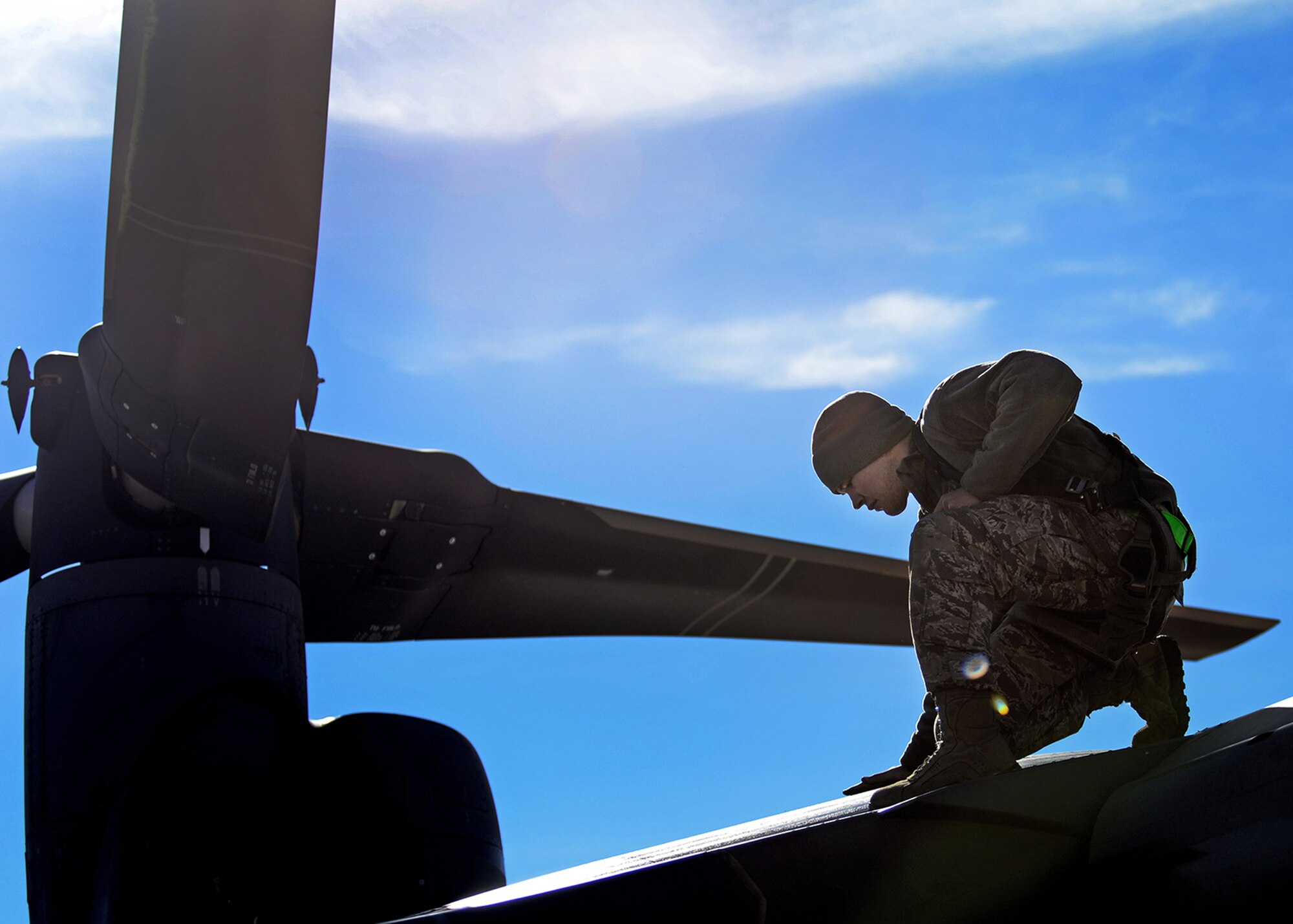 An Air Commando with the 727th Special Operations Aircraft Maintenance Squadron conducts an aircraft inspection on a CV-22 Osprey Dec. 18, 2014 at Cannon Air Force Base, N.M. The 727 SOAMXS focuses on training personnel to maintain and sustain the CV-22 Osprey tilt-rotor aircraft, as well as the MQ-1 Predator and MQ-9 Reaper remotely piloted aircraft. (U.S. Air Force photo/Airman 1st Class Chip Slack) 