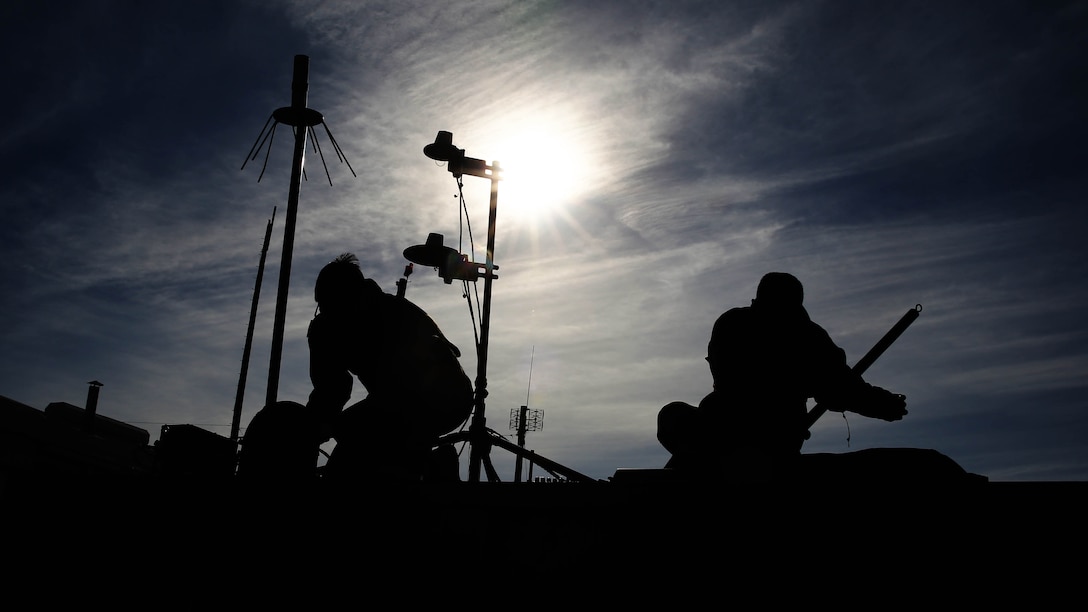 Lance Cpl. Homero Campos, left, and Lance Cpl. Chara J. Savoey, set up a hasty communications tower at Bombing Target Range 11, Piney Island, N.C., Dec. 18, 2014. Campos is an unmanned aerial vehicle maintainer with Marine Unmanned Aerial Vehicle Squadron 2 and native of Kingston, N.Y. Savoey is a field radio operator with the squadron and is native of Oakland, Calif.