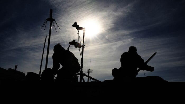 Lance Cpl. Homero Campos, left, and Lance Cpl. Chara J. Savoey, set up a hasty communications tower at Bombing Target Range 11, Piney Island, N.C., Dec. 18, 2014. Campos is an unmanned aerial vehicle maintainer with Marine Unmanned Aerial Vehicle Squadron 2 and native of Kingston, N.Y. Savoey is a field radio operator with the squadron and is native of Oakland, Calif.