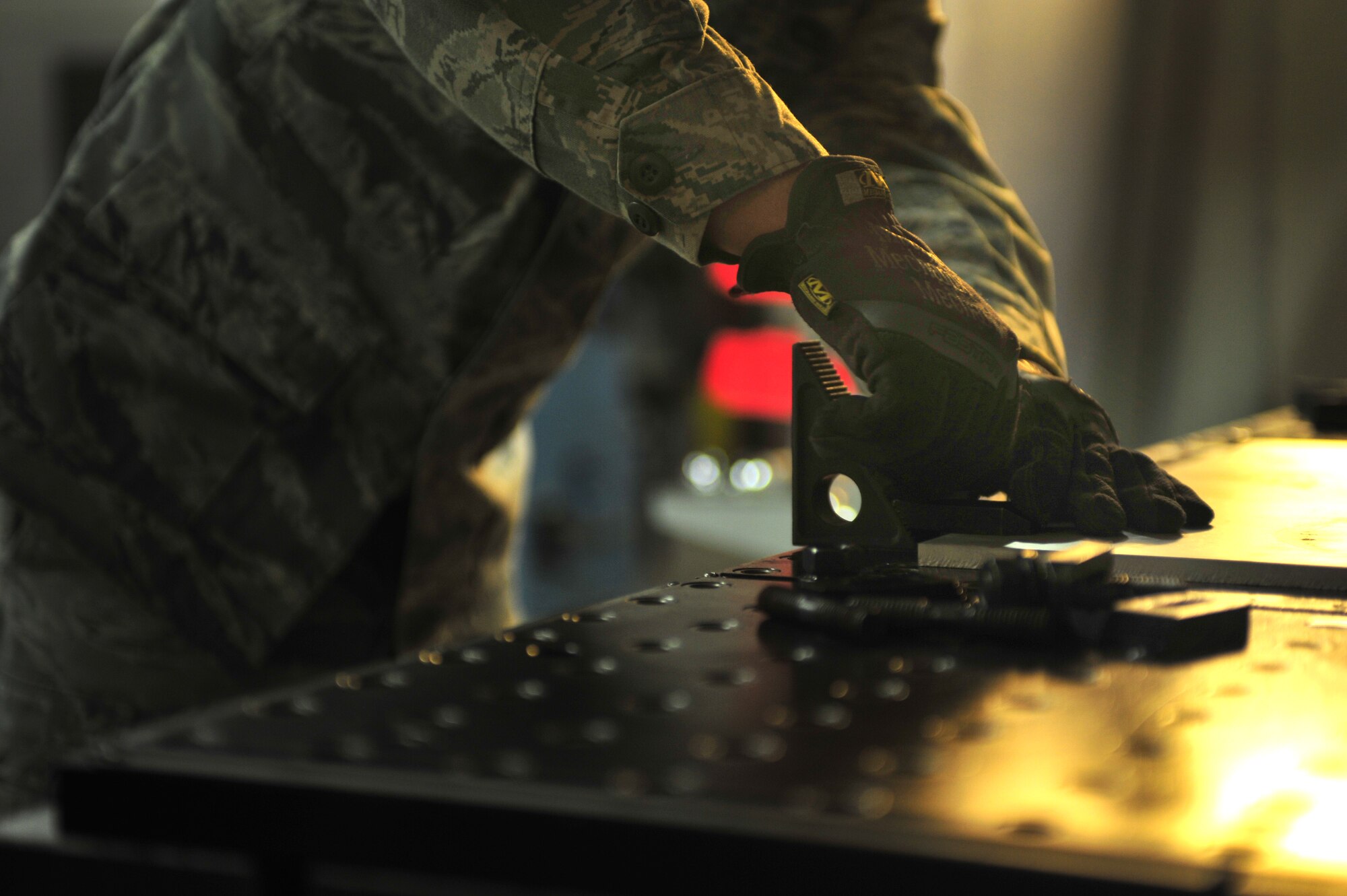 A maintainer with the 27th Special Operations Maintenance Squadron performs maintenance on machining equipment Dec. 18, 2014 at Cannon Air Force Base, N.M. Aircraft metals technology specialists maintain welding equipment and adjust jibs, clutches and feed screws. (U.S. Air Force photo/Senior Airman Eboni Reece)
