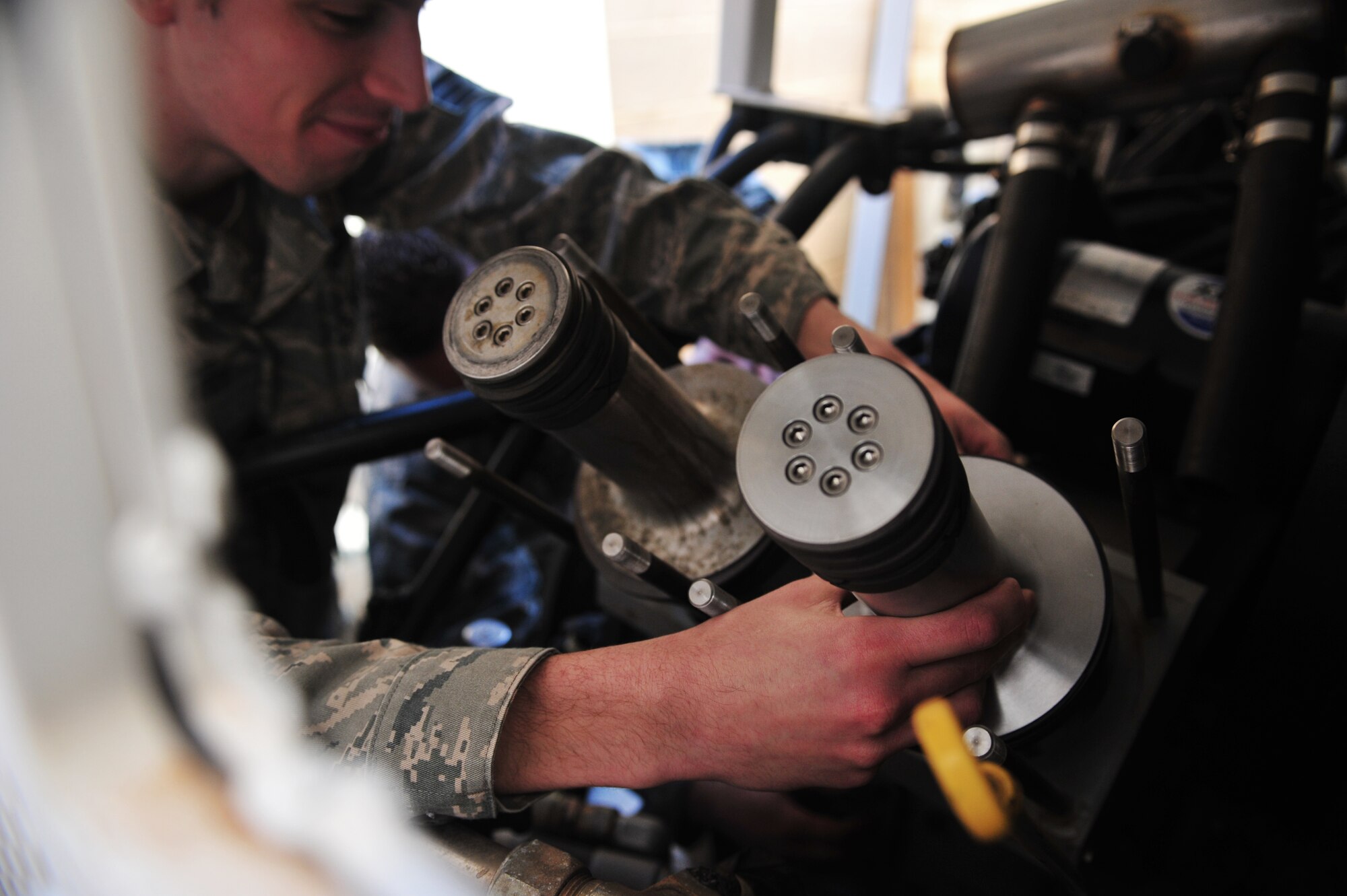 A maintainer with the 27th Special Operations Maintenance Squadron installs a piece of equipment Dec. 18, 2014 at Cannon Air Force Base, N.M. The 27 SOMXS utilizes 11 career fields to perform intermediate and organizational-level maintenance on assigned aircraft. (U.S. Air Force photo/Senior Airman Eboni Reece)