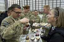 Deanie Dempsey hands out donated cupcakes after a USO show in Bagram Airfield, Afghanistan, Dec. 9, 2014.