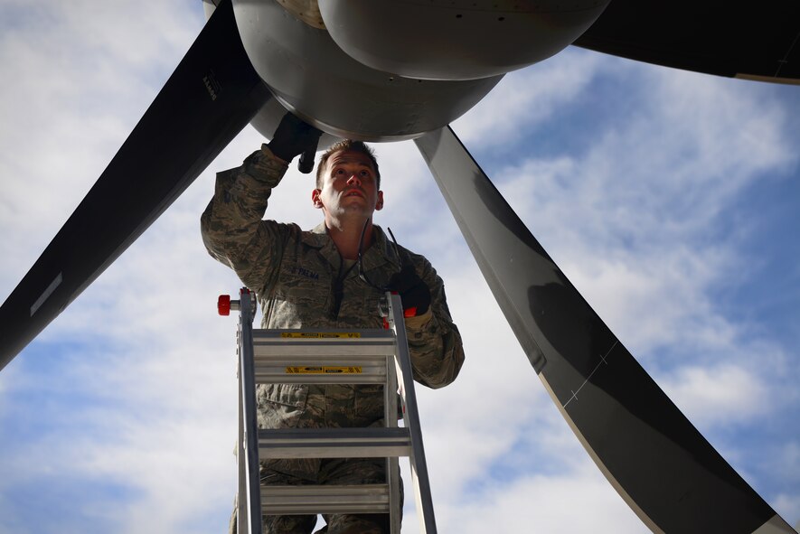 U.S. Air Force Tech. Sgt. James DiPalma, 27th Special Operations Aircraft Maintenance Squadron crew chief, performs intake and exhaust checks on an MC-130J Commando II Dec. 18, 2014 at Cannon Air Force Base, N.M. The checks ensure that there are no foreign objects endangering the gunship’s engines. (U.S. Air Force Photo/Airman 1st Class Shelby Kay-Fantozzi) 