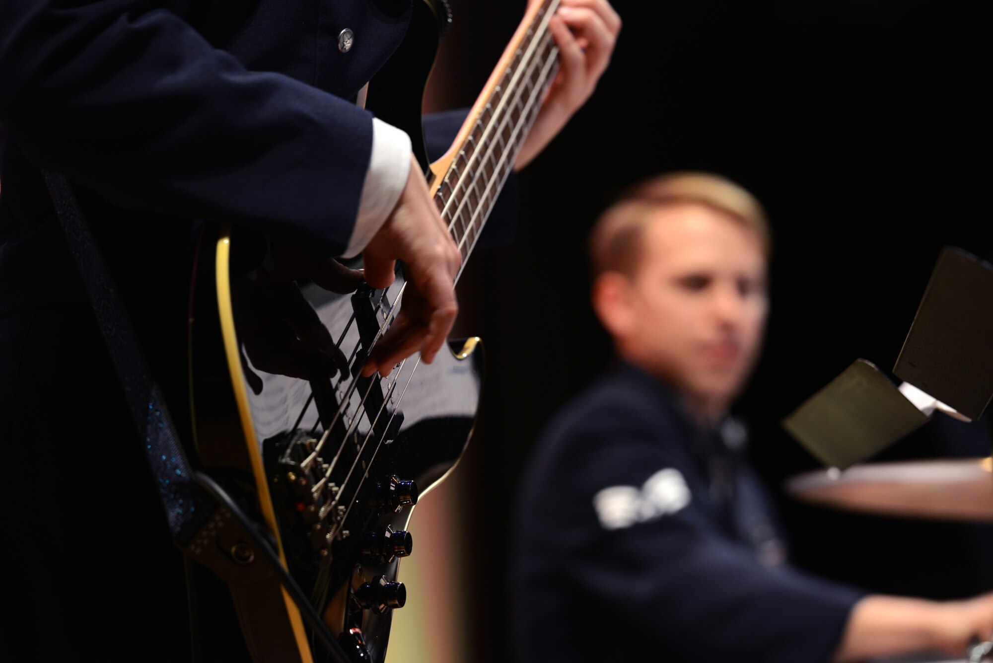 U.S. Air Force Airman 1st Class Emily Wheaton, U.S. Air Force Band of the Pacific-Asia bassist, and Senior Airman Benjamin Johnson, percussionist for the band, perform during a frienship concert in Naha, Japan, Dec. 11, 2014. During the two-hour concert, members of the band sang, danced and played to an audience of more than 450 local Okinawan citizens as a way to return some hospitality to the host nation. The concert was one of four during the band's tour of Okinawa. (U.S. Air Force photo by Senior Airman Maeson L. Elleman)