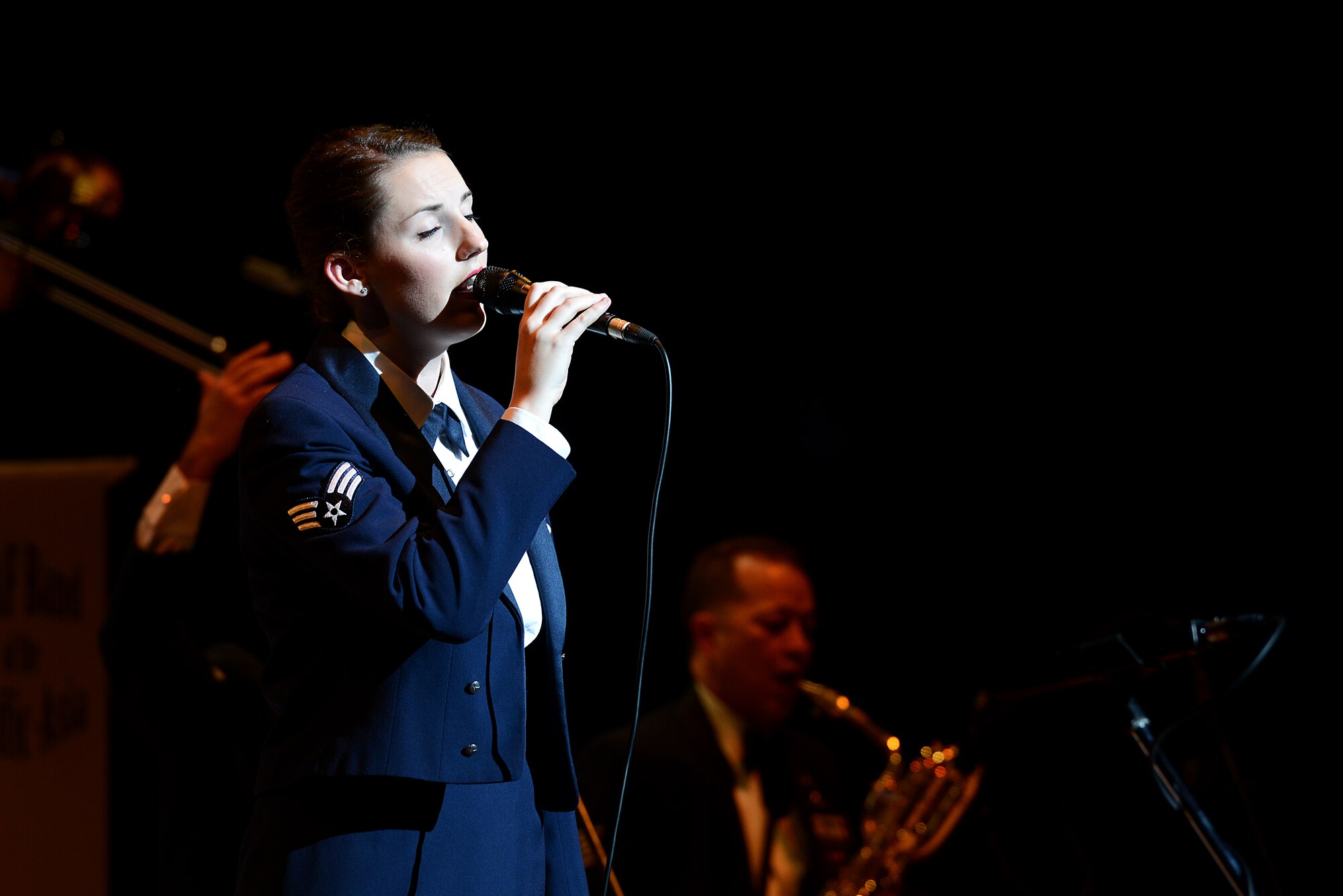 U.S. Air Force Senior Airman Rebecca Allen, vocalist for the U.S. Air Force Band of the Pacific-Asia jazz ensemble, performs during a friendship concert in Naha, Japan, Dec. 11, 2014. The concert, which was sponsored by the bi-lingual, multi-cultural Okinawa Keystone Lion's Club, was held as a means to show appreciation for the local community. (U.S. Air Force photo by Senior Airman Maeson L. Elleman)