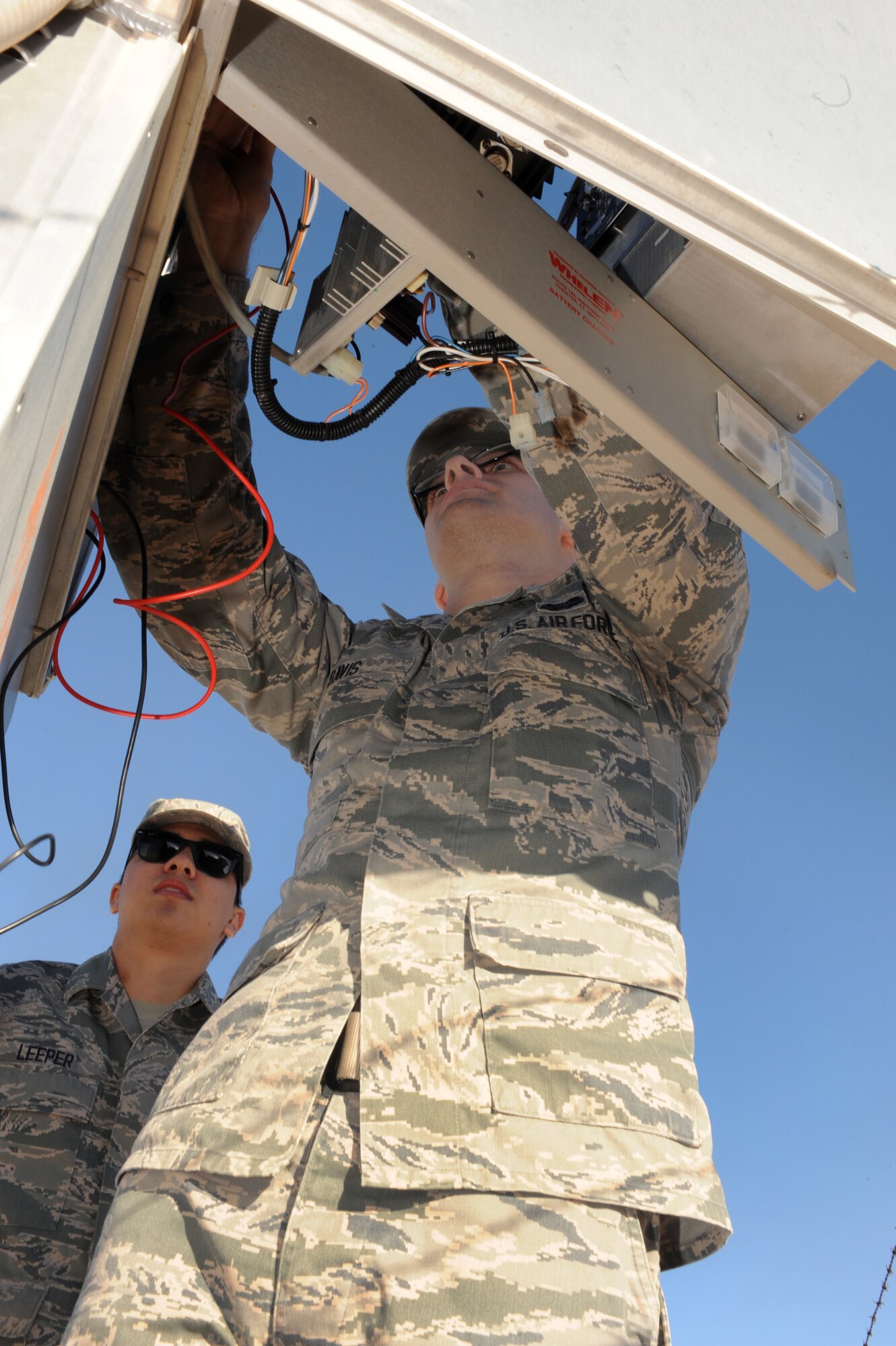 U.S. Air Force Senior Airmen Kevin Davis and Garrett Leeper, 355th Communications Squadron radio frequency transmissions systems technicians, perform a preventive maintenance inspection on a giant voice pole at Davis-Monthan Air Force Base, Ariz., Dec. 22, 2014. Checking the poles and amplifiers ensures base emergency warning systems remain operational. (U.S. Air Force photo by Airman 1st Class Cheyenne Morigeau/Released)
